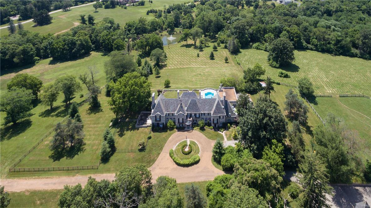 HUGE PRICE ADJUSTMENT!  MARITZ & YOUNG Designed Estate Mansion in Huntleigh!  Beauty, Elegance, Charm-YOU NAME IT!   Ideal for Entertaining!   The Present Owner has Millions in Awesome Improvements & Updates! Exquisiteness & Exclusivity of the Original Home is Still Present!  Six Plus Beautiful Peaceful Rolling Acres, Stocked Pond, Horse Ready Corral, Barn & Stable, Fenced Pasture. Phenomenal Newer Kitchen with Every Luxury Amenity Possible-Butler's Pantry, Twenty-Two Rooms-Private Driveway-Three Floors Plus Finished Lower Level with Bar Areas, Theater, Wine Cellar, Large Recreation and Billiard Room.  Maids Quarters Plus In-Law Quarters, Balconies, Six Bedrooms, Four Full & Five Half Baths, Terrazzo Floors, Five Fireplaces, Four Car Garage, Circular Drive, Very Private Setting, Large Pool with Outdoor Fireplace, Two Laundry Areas.  Stately Architecture.  Owned Over the Years by Prominent St. Louis Families. Magnificent! A Pleasure to Own & Enjoy!  Call Today for a Private Showing.