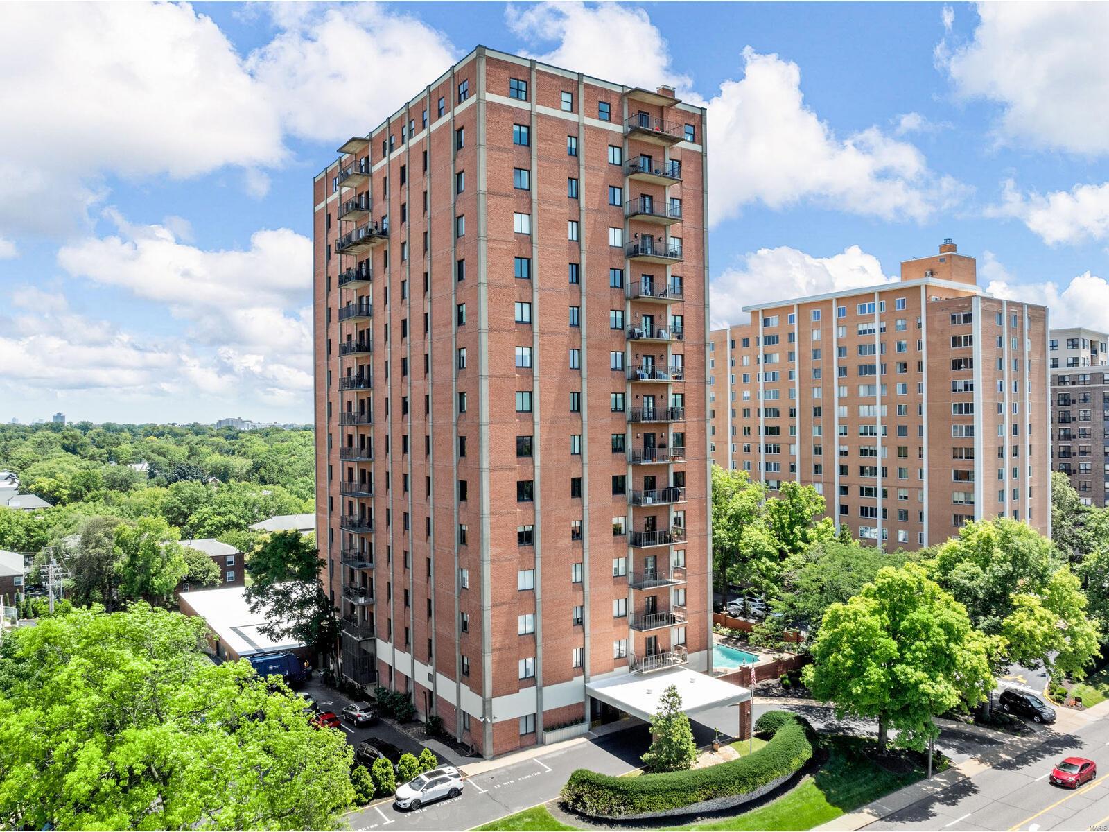 Welcome home to this beautiful condo with panoramic views in the heart of Clayton!  You can see the Arch, Busch Stadium, and downtown Clayton (fabulous east facing patio and many east and south windows). The kitchen has been updated with new custom cabinets, stainless steel appliances, and granite countertops. The bathrooms are updated as well.  The interior is open, warm and inviting.  Great flow from dining room, living room and family room/den.  Flooded with light, this unit is special.  The primary suite has a spacious renovated bath and walk in closet.  The guest bedroom has a Murphy bed and custom built-ins for a great office.  Separate laundry room, 9ft. ceilings, fabulous molding, tons of storage and 1 (maybe 2) assigned parking spaces! The building has undergone major renovations...beautiful lobby, party room, full kitchen, guest suite and heated outdoor pool. The building has many events & happy hours if interested. Make your appointments. Run, don't walk! Some Accessible Features Location: End Unit, Upper Level
