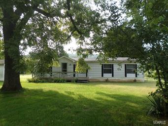 very nice, working cattle farm, with about 40 acres in pastures, (2) ponds, with one being spring fed, property is completely fenced and cross fenced, and joins Conservation land, mostly level pastures, with sloping wooded land. The home is a 1986 double wide home 26'x56', w/ 3 bdrms, 2 baths, all electric /F/A furnace, C/A, with covered back porch, deck on front, has large metal barn in back 32'x40' with workshop and chicken house..close to Johnson Shut'Ins State Park and conservation land..Nice setting and location...