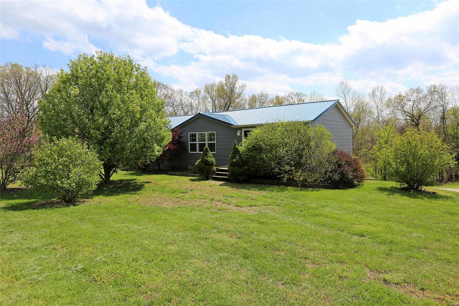 3BR/3BA MOVE-IN-READY RANCH ON 4 ACRES! Country living just 7 minutes off of Hwy 21! Enter to living room w/3 large windows, electric fireplace w/mantle, & vaulted ceiling that extends over entire main level! Kitchen boasts white cabinets & white appliances (refrigerator stays!), 2 ceiling fans, ceramic tile floor, & HUGE center island that seats 6. Sliding glass door leads to covered deck w/ceiling fan--enjoy the peaceful view of large back yard that backs to woods. Back inside, handy utility room is adjacent to kitchen--washer/dryer both stay! Main floor master is roomy & boasts large walk-in closet & private bath w/dual sinks. Two more bedrooms & a hall bath round out the main level. Walk-out lower level provides addt'l living areas--kids will love the 27x16 family room w/direct access to backyard & covered concrete patio, plus a 25x25 rec-room w/adjacent 15x8 wet bar/kitchen area, 3rd full bath, & 14x9 workshop. Large shed & kids' clubhouse with full electric both stay!