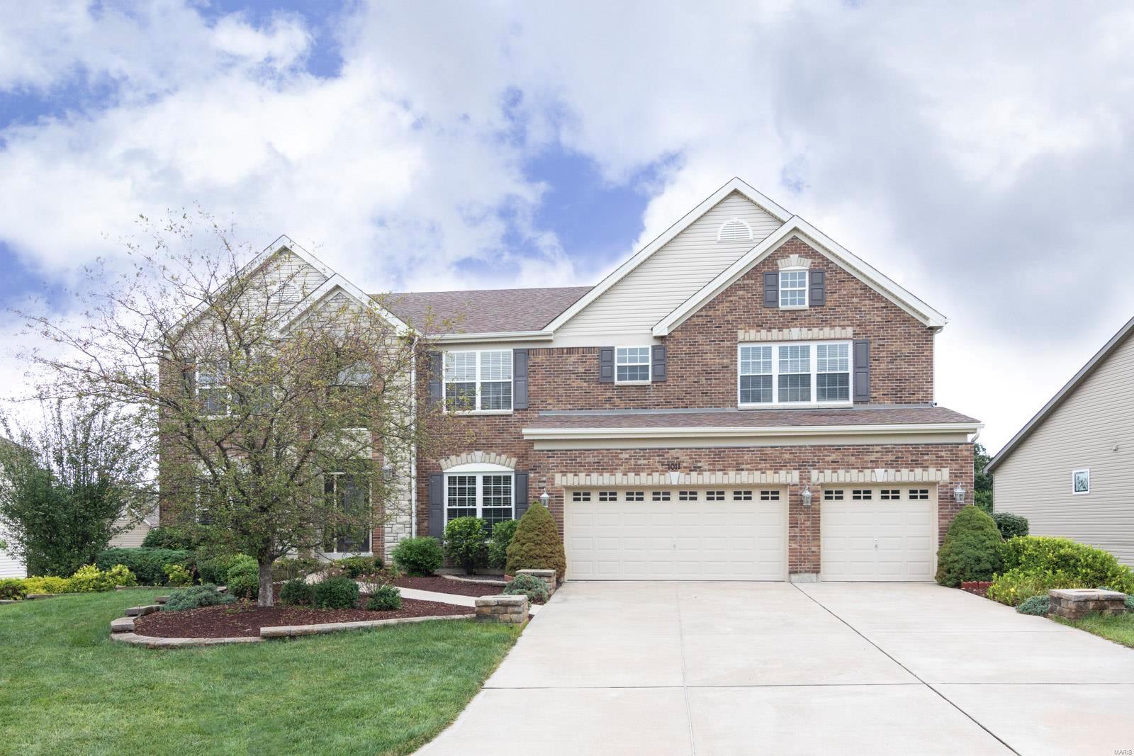 New Price! Welcome to this Taylor-Morley custom designed home with all the extras! Beautiful crown molding, built-in custom bookshelves, coffered ceilings. Spacious LR features wall of windows, natural light, brick gas fireplace & built-in bookshelves. Formal dining room. Gourmet kitchen—custom cabinetry, granite breakfast island & countertops, SS appliances & walk-in pantry—opens to breakfast and family room w/fireplace, buffet w/built-in wine rack & maintenance-free balcony. Open stairs w/wrought iron spindles lead to upper level. Two Master Suites, separate living area and Two additional bedrooms w/shared bathroom. Main Master features amazing huge bathroom w/jacuzzi soaking tub, separate shower, leaded windows, custom cabinets. Custom, plantation blinds throughout. Main floor laundry, zoned HVAC, 3-car oversized garage, unfinished basement w/rough-in, Irrigation system. Amenities include clubhouse, swimming pool, tennis courts & easy access to top-rated Wentzville R-IV Schools.
