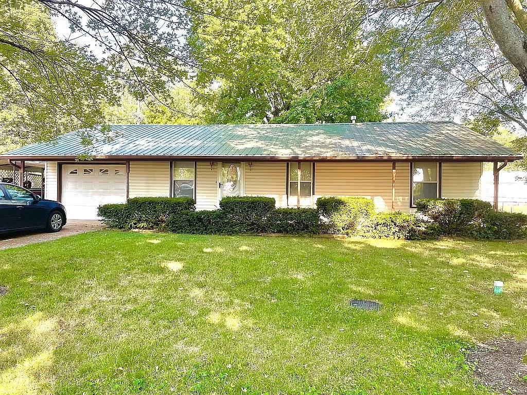 Check out this immensely maintained and beautiful home! Nice open floor plan with a completely custom kitchen with beautiful cabinetry. Nice sized living room with charming authentic built ins surrounding the fire place, making this space especially inviting for family and friends. Outside you will notice the huge fenced in backyard, lots of mature trees to give you plenty of shade during the hot summer months, a large deck perfect for entertaining all year around, covered front porch and a utility shed for extra storage. Attached garage with detached carport and storage area. This home has been very well maintained its entire life. New metal roof in 2012. Home was updated in 2020. Some of those updates include all new flooring throughout, trim and doors. This home will not last long! Schedule a showing today!