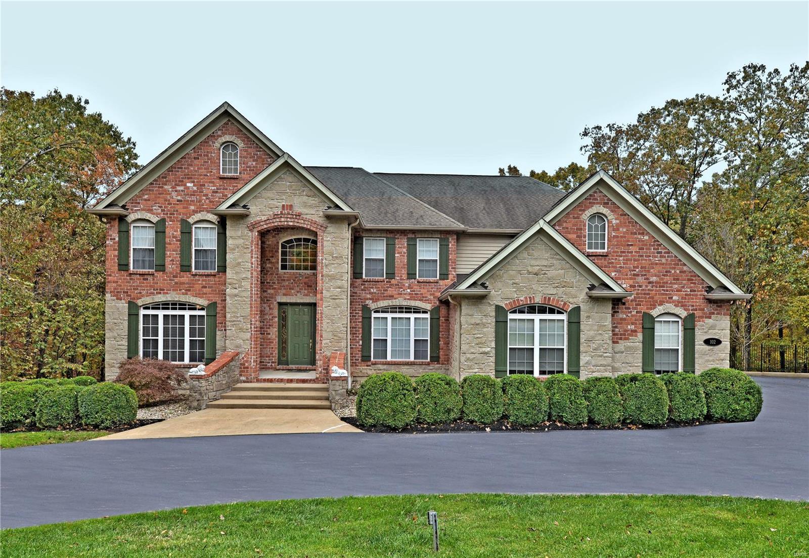 A striking brick and stone front elevation and beautiful landscaping create high curb appeal for this custom Pevely 1.5 Story.  The home features 4 bedrooms, 4.5 baths and over 5,500 square feet of well appointed living space.  Special amenities include an open floor plan, 9', vaulted and soaring 2 story ceilings, hardwood and tile flooring, front and rear staircases, balconies, French doors, millwork, built-in cabinetry, plant shelves, 2 fireplaces, floor-to-ceiling and palladian windows, 8' main level paneled doors with lever hardware, updated lighting fixtures, and 2" and silhouette blinds.  Set on a picturesque and private 2.57 acre cul-de-sac lot, backing to woods, with an inviting fenced patio....This home is conveniently located just minutes from shopping, dining, and access to I-55.

Make your appointment TODAY....Before it's SOLD tomorrow! Additional Rooms: Sun Room
