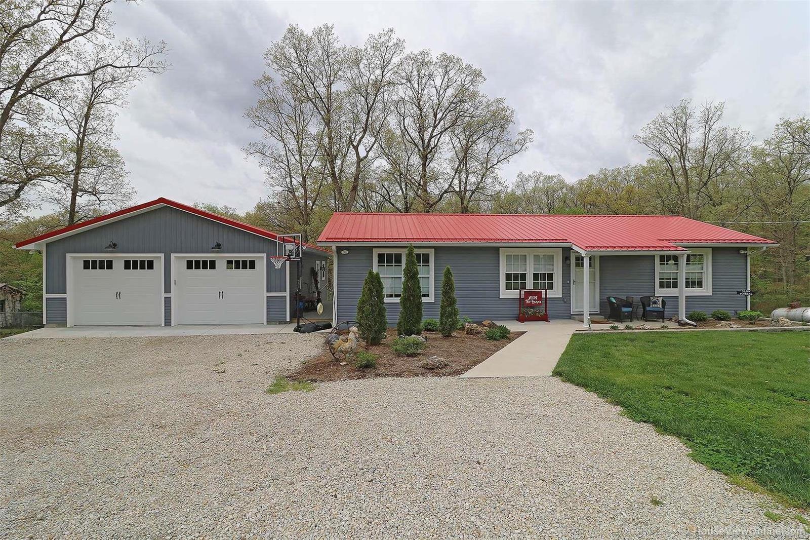 Totally renovated with the highest standards & design this wonderful 3 bedroom & 2 1/2 bath is situated on 2.51 acres. Mature woods with beautiful landscaping creates a park like setting oasis which can be admired on the covered front porch or 12 x 26 composite deck. 26 x 34 detached garage with 9 ft walls, two 8-ft tall doors, insulated, LED lighting & custom shelving. Newer windows showcase the open floor plan with divided bedrooms. Pecan hardwood is showcased throughout the main living area. The kitchen is presents an eclectic mix of woods & finishes,custom cabinets, quartz countertops & stainless steel appliances. Master suite hosts spa-like bath w/ heated tile floor with programmable thermostat, custom closet & one of two washer & dryer hook-ups. Sure to be a family favorite is the additional living space in the lower level with family room, half bath, walk out & ample storage space in unfinished area. Additional features include, new electric, plumbing, HVAC, metal roof & siding.