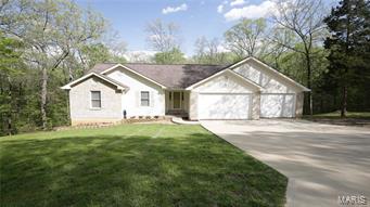 Live in a gated Community with privacy like living in the Country! One Owner home! Home will be sold with 2 additional lots, one on each side! 5 Bedrooms, 3 Full Baths, Great Room-Open floor plan! Large Kitchen with Stainless Appliances, newer counter tops & access to Laundry Rm, Dinning Rm, Garage, & Lower Level! Concrete, Over sized driveway for 3 car garage. 3rd car space 38'+/- deep for boat/trailer. Large Foyer welcomes you to Great Rm & Open Floor Plan! Kitchen, Dinning Rm, Main floor Laundry, Foyer, & lower level Bathroom has newer Porcelain Tile. Dining Rm has walkout to Deck that is great for BBQ. Lower level walkout with 2 more Bedrooms & Large, New, Full Bathroom, Recreation Room, & Storage Area. Walk out to a covered Deck that allows you to view the private wooded back yard! Lake Development allows access to all Lakes. Enjoy fishing, swimming, boating, Holiday Activities (fireworks, Easter Egg Hunt, Halloween Hay Ride, Etc.. Home has a Home Warranty paid by Seller!