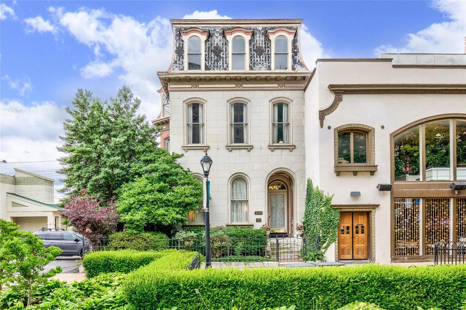 BOM! Beautiful restoration in the heart of Grand Center! This 5,000+sf space has been renovated with so much attention to detail. Gorgeous fireplaces, 12’ ceilings, beautiful pocket doors/woodwork, hand painted & stenciled accents, and the list goes on. Currently used as office/law practice, can be used as both residential and commercial. Full kitchen & two ½ baths on 1st floor with stunning common rooms that can be used as living & dining rooms or office. 2nd floor has 3 bedrooms or offices with ensuites plus a great little wet bar. 3rd floor is wide open for studio space, office space, rec room - so many options. Roof top deck with amazing views, 2 car garage+3 additional gated parking spaces, partially finished lower level with walkout to garden. Grand Center common area in front, next door to Jazz at the Bistro, Fox Theater, Powell Symphony Hall. Could be your dream home, B&B, speakeasy, art gallery - So many options!