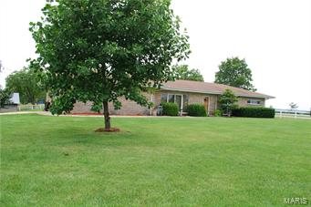 Immaculate 3bed/2bath ranch home near Licking sets on 100 acres. The kitchens have hickory and oak cabinets, gas and electric range/oven and gorgeous hardwood floors. There are hardwood floors throughout the house except in the bathrooms. The fireplace sets in a beautiful brick wall at one end of the living room. There is also a new propane furnace as well as new windows and roof. The property also features a 40x60 metal building, Hardy outdoor wood furnace, 395 ft well & rural water,30x50 barn, fencing/cross fencing, wood shed, chicken house, and 2 fresh waterers for cattle. The land has been limed and fertilized and has 2 ponds (one is spring-fed). Property is conveniently located 3 miles from Licking, Mo on paved blacktop road. 30 minutes from Rolla,Mo. and 9 miles from Montauk State Park