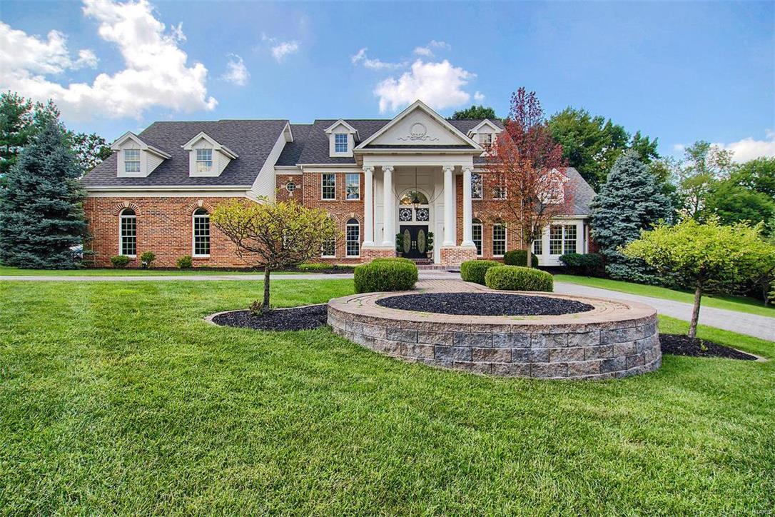 Professionally designed and renovated:St. Louis Real estate at its finest! Strong, stately, and sophisticated curb appeal. The foyer is massive and inviting and will pull your attention in so many directions: to the right your formal sitting or office, the left your formal dining, straight ahead your show stopping great room with wood burning fire place accented with light stone, built in wet bar/wine cooler, and soaring ceilings! Main floor master with his/her closets, Marble bathroom with soaking tub. The kitchen is an entertainers dream:High end appliances, custom cabinetry and professionally scouted counter tops! Living room connected to kitchen and walk out to your in ground heated pool/spa oasis. Upstairs you have 3+ additional bedrooms, 3 full baths and a MASSIVE media/theater  room. Basement is fully finished with bar, media area with built-in bookcases, bedroom, 2 more baths! and workout, yoga, dance studio with ANOTHER walk out to the backyard/fire pit patio area. SHOWSTOPPER