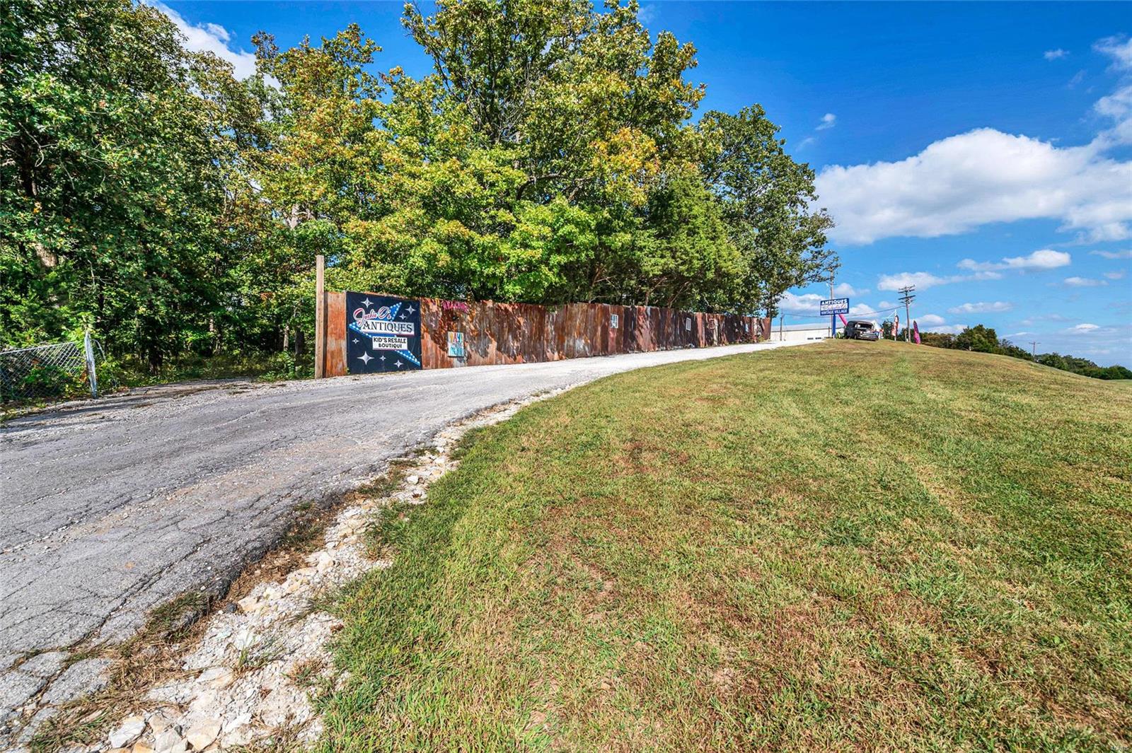 ENDLESS OPPORTUNITY RIGHT HERE!! AWESOME LOCATION!Take advantage of this High Visibility 19+ Acre property w/ a TON of improvements!Currently used as Auction House,(Jackie O's)-The 8400 sq ft, AMISH Built Building w/ Handicap bathrooms, Full kit, Office, dressing rooms, concrete flr, electric, 12' Garage dr & full HVAC!Additionally, a 70X40 Multi-purpose Commercial build.,previously a church, & then a resale store,& A 48X30 pole & metal structure unattached garage/shop building w/ 2 roll-up doors, concrete flr & electric.Lastly,(3) sets of storage units, 30X18=18units, double deep, 220X15=25 units,& 140X30!Truly, a Beautiful piece of land, approximately 1/2 woods (with pond) & 1/2 pasture land.There is a deep well, septic, & asphalt as well as gravel parking lots. Manufactured Home is on public water.  CALL listing agent for your Private showing today- LAND, Improvements, & possibly inventory is for sale- NOT the Biz itself. All leases w/ the rental units will go to the new owners.