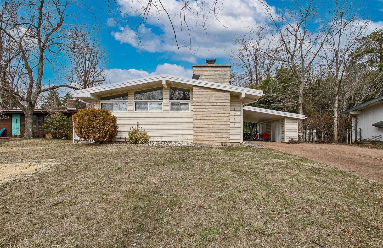 Charming mid-century ranch in Lindbergh Schools! Modern décor meets mid-century design in this 3 bedroom/1 bath open-floor plan home. You'll love the family room featuring vaulted ceiling, beautiful floor-to-ceiling stone wood-burning fireplace, rustic floors and original sliding pocket doors. Other distinguished features include built-in bookcases, newer windows, electrical panel, wood-tone & ceramic tile floors, granite countertop, stainless appliances, retro chandelier and custom storage/closet system in the master bedroom. Third bedroom can also double as a cozy den or home office. Main floor laundry with utility sink, partially fenced & private backyard, covered carport with plenty of storage & parking, separate patio off the kitchen and sellers are including the storage shed.