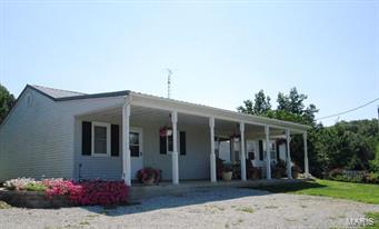 Home completely refurbished in 2001, including wiring, plumbing, windows, cabinets etc. You will love the setting of this home on 16.1 acres. Home features kitchen/dining combination, open living room, one huge bedroom (could be converted into two bedrooms) large bathroom, laundry/storage and office area.  You have a 3-car detached garage with concrete floors and electric.  Also there is a 30 x 56 building with plenty of storage and workshop area. The 16 acres consist of 5 ponds (4 of them stocked) open ground and woods.  It is partially fenced with plenty of wildlife.   Lots of flowers, koi pond, and an abundance of apple trees, pecan and English walnut and blackberries. Located within 8 miles of Palmyra. Properties like this don't come along very often so you will want to check it out.
