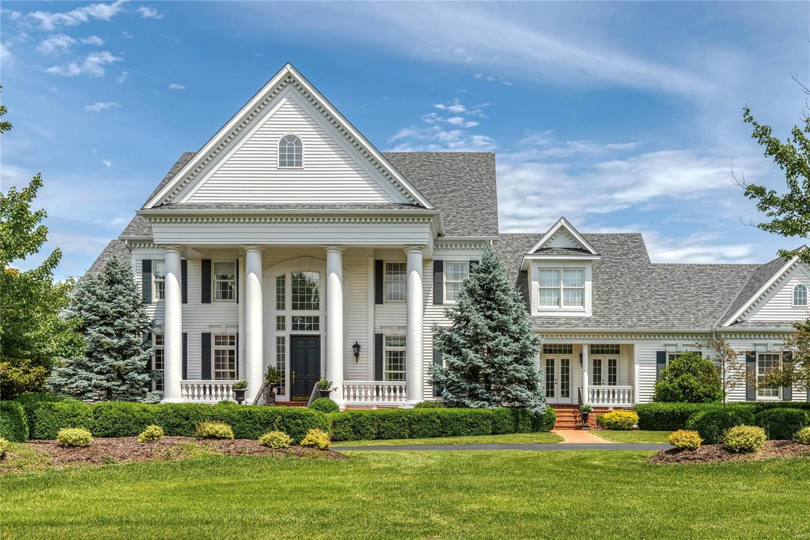 A truly magnificent Colonial in one of Town & Country’s most desirable neighborhoods! Grand 2-sty marble foyer highlighted by floating staircase leads to library-paneled study with box beam ceiling & built-in bookcases, elegant dining room framed by arched entryways & stunning great room with 2-sty palladian windows, marble fireplace with full-height mantel & wet bar. Designer kitchen featuring cherry cabinetry, granite countertops, commercial grade appliances, double islands & convenient planning center adjoins breakfast room with 2 sets of French doors & vaulted hearth room with floor-to-ceiling stone fireplace. Coffered master bedroom suite provides an appealing retreat with His & Hers walk-in closets & marble bath with fireplace, shower spa & Jacuzzi. Front & rear staircases access 4 additional bedrooms, 2 with ensuite baths & 2 with Jack n’ Jill bath. Outdoor living area includes wrap around deck & stone terrace surrounded by landscaped gardens plus circular drive & 4-car garage.