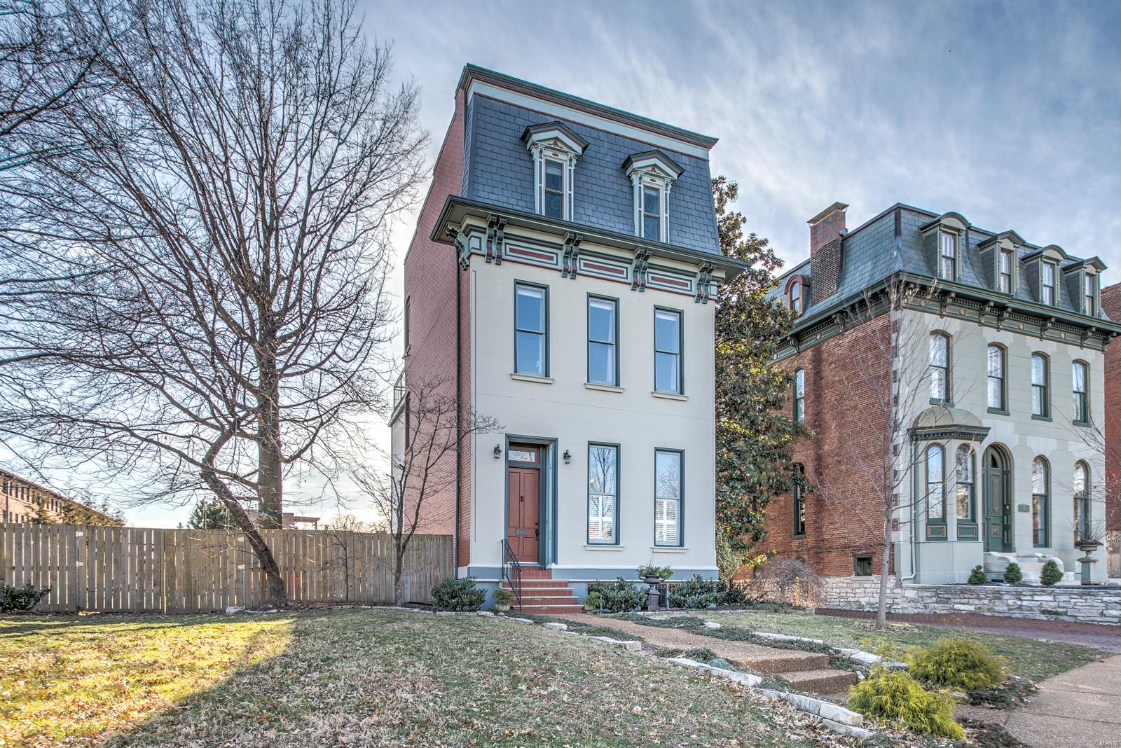 THE PLACE. The newest home on the oldest private street west of the Mississippi. Sitting at the end of the cul-de-sac across from the center of Lafayette Park on a oversized double lot. Amazing hardwood floors across the main level. Double-sided working fireplace in living & dining. Coat closet, pantry, spacious half bath and a top-notch kitchen and sunroom perfect the first floor. Kitchen has double stacked premium wood white shaker cabinets, high-end appliances, thick granite countertops, it's a great light filled room. 2nd floor features two bedrooms with private baths. The master suite has a wall of windows with views of the beautiful, old growth, median park as well as laundry hookups, a walk-in closet and premium shower with double vanities. Top floor is the best! A walk out rooftop deck is amazing for 4th of July fireworks! Family room and 3rd bedroom suite are terrific. Lower level with full laundry, play room and storage. Plus a 2 car garage! This is where you want to be!