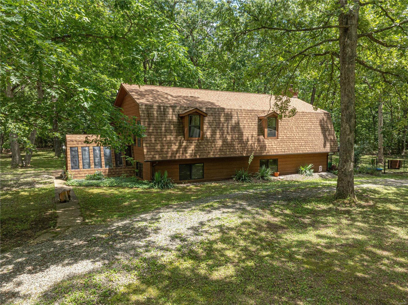 This incredible 3 bedroom, 2 bathroom cedar home is situated on a serene park-like setting with just over 10 flat acres!! This home features huge vaulted ceiling donned with beautiful car siding and a stunning floor-to-ceiling brick wood-burning fireplace. The main living space is boasting with natural light from the large windows. The main floor includes the spacious living room, kitchen, dining room, main floor master and main floor laundry! Upstairs enjoy the view from the expansive loft! Two more generous sized bedrooms and a huge bathroom complete the upper level. Water heater new 2024! This gorgeous and unique property is a MUST SEE!
GPS may take you to the neighbors house - Follow Hickory Dr to Dead End - Last House on the Right! Suitable for Bed/Brk