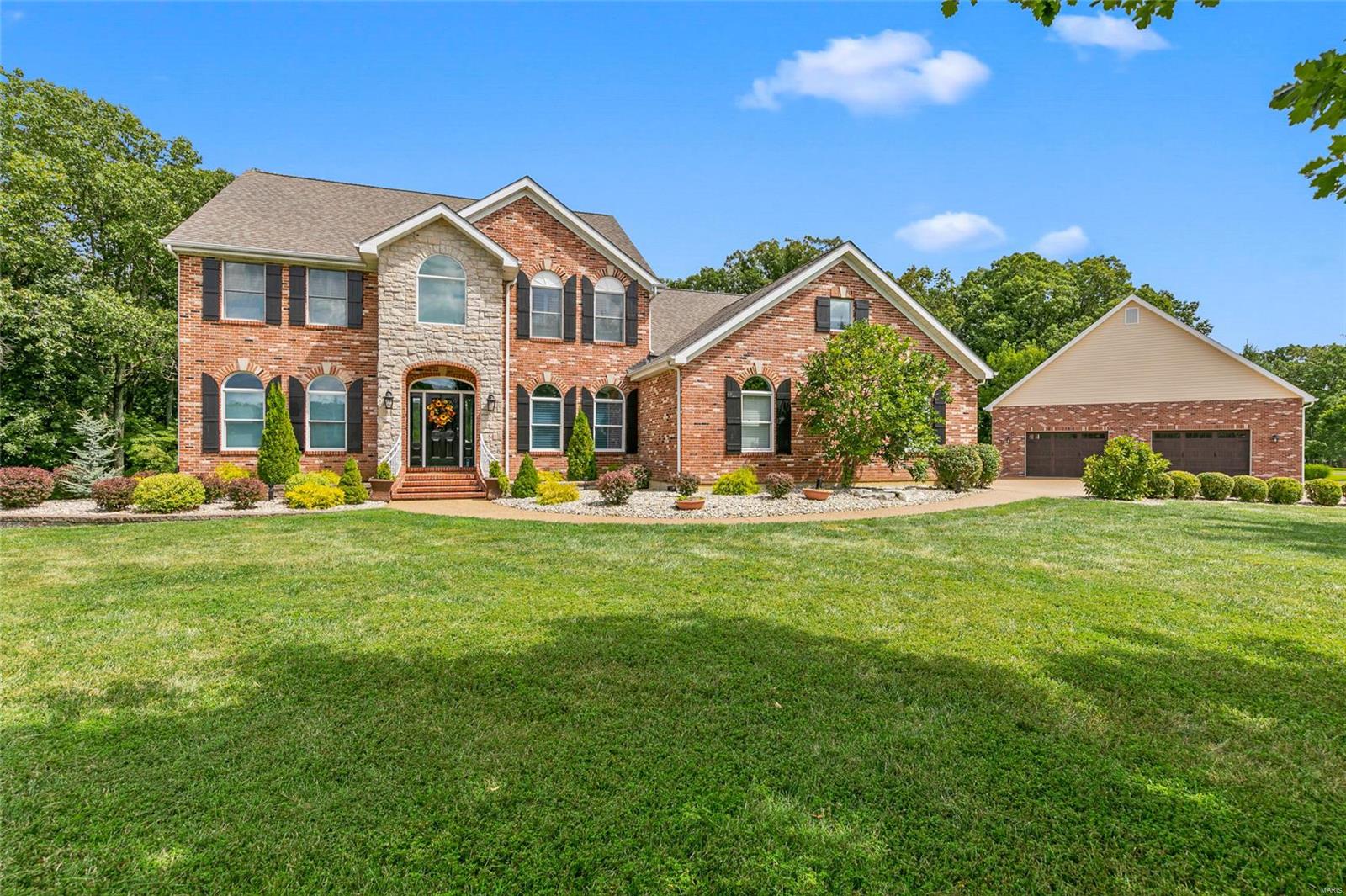 So much house & so little space to tell you about this incredible three sided brick, 1.5 story home built with elegance & comfort in mind. Impressive hardwood entry with formal dining has 4+ bedrooms, 5 full & 1 half baths, a complete home office with built in furniture & cabinetry, mud room with cubbies & main floor laundry with cabinetry & sink. This amazing kitchen has a 5X8 custom center island/ breakfast bar with built-in bookcases, Quartz countertops, microwave drawer, beverage cooler, desk, stainless high end appliances, commercial refrigerator, gas cooktop with griddle & double oven. The upstairs bonus & work out rooms are spacious & inviting. The lower level finish includes a family/rec area, wet bar, safe room & unfinished storage. There is a 3 car attached garage & a 40x40 insulated, detached, matching garage with Hardee board interior walls & room for 8 cars. Chicken coop, hot tub, deck & outdoor kitchen area plus 168 acre Callaway Valley lake rights complete this package.