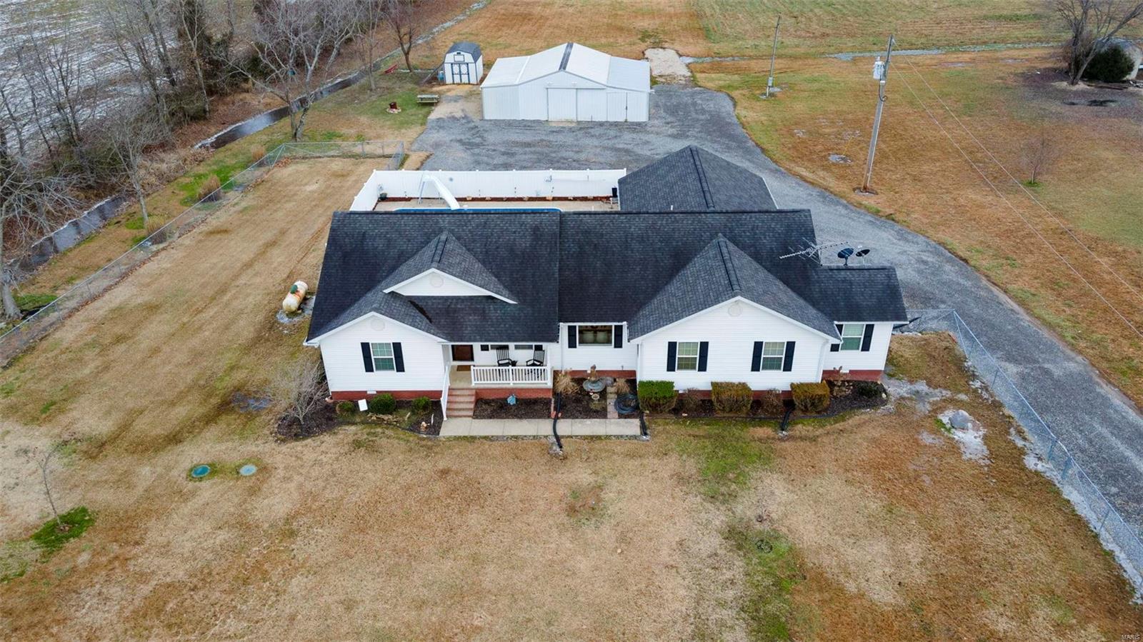 RARE OPPORTUNITY FOR HUNTERS AND NATURE LOVERS! This is your fleeting chance to own a beautiful home on 4.36 fenced acres, only 1/4 mile from 460 acres of Greenbrier Conservation land. This meticulously maintained home features spacious rooms, including a gorgeous home chef's kitchen, formal dining room (or office if you prefer), front-to-back living room, and luxurious primary suite with huge walk-in and spa-like bath. The bedrooms feature new carpet, and the majority of the home has been freshly painted. Outside, enjoy an 18x36 HEATED SALTWATER POOL, upgraded in 2024 (new filter, liner, & seals), with a spacious patio and outdoor speakers. Practical perks include a multipurpose utility room, geothermal heating/cooling, Starlink internet availability, a well with a new pump, a septic system (serviced '23), a HEATED SHOP, and a shed (currently a cluck cottage). With no HOA and FURNISHINGS AVAILABLE WITH PURCHASE, you won't want to leave. Your slice of paradise is waiting—call today!