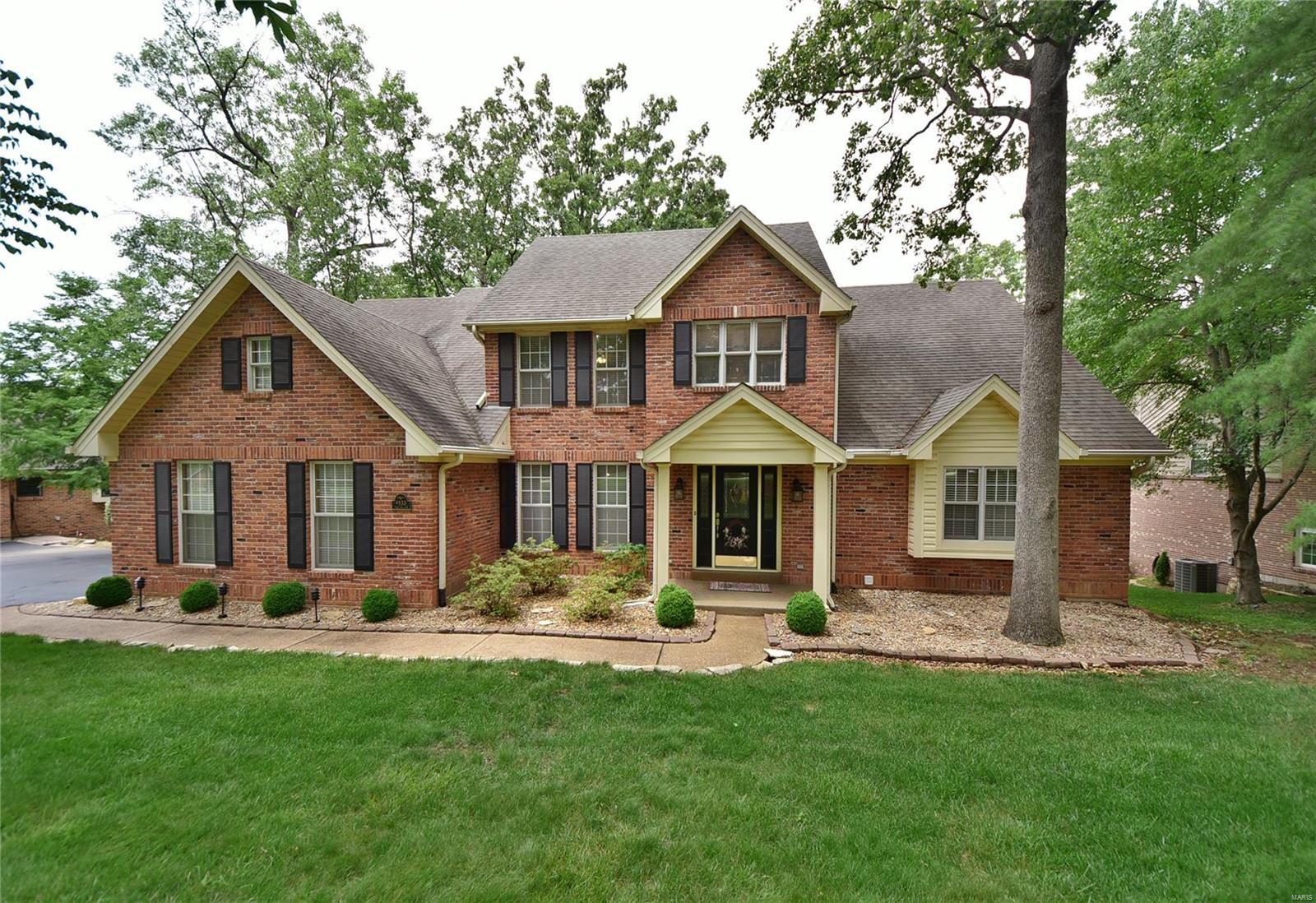 Sprawling 1.5 story all-brick home includes 4 bedrms + 2 full & 2 half baths. The inviting open floorplan boasts a soaring 2-story entry foyer w/ gleaming hardwood flooring that continues through most of the main floor. The great room features a floor-to-ceiling brick fireplace, vaulted ceiling & atrium walkout to the large elevated deck. You will love the bright & inviting eat-in kitchen with vaulted ceilings, decorative stone tile backsplash, Silestone counters, planning desk & adjacent breakfast room.  Pella windows & six panel doors throughout! Retire in comfort to the oversized master suite w/ a walk-in closet & luxurious private bath with whirlpool tub. Upstairs features two bedrooms and an additional loft area that can be used as a bedroom. The finished walk-out lower level adds a family room w/ 2nd fireplace + 4th bedroom, half bath, den & a huge bonus room/workshop.  All this on a large .84 acre lot!  Seller is offering a $5000 credit for flooring and/or painting.