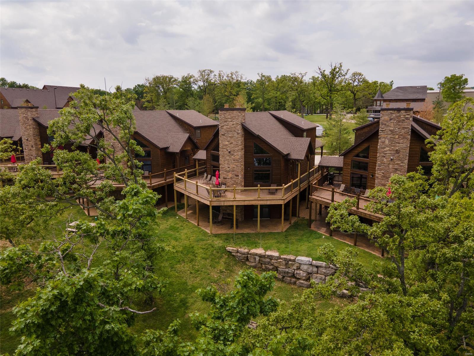 ONE OF THE BEST LOCATIONS ON TABLE ROCK LAKE, the gentle slopes of the Ozark Mountains in Branson Shores on Stormy Point are calling your name! This rustic 6 BR/3 BA cabin is a short 4 miles from Silver Dollar City & only 3.5 miles to Branson. With its spectacular view, Branson Shores is a vacation & rental investment dream. From a zero-entry pool, sand volleyball, to its gorgeous sunrises, this masterfully built cabin comes fully furnished & is turnkey for your vacation home or investment property goals & dreams. As the owner, you'll be able to stay as much as you wish. You & your guests will enjoy all this property has to offer. Fishing, skiing, hiking, boating, cliff jumping, amusement parks, live music shows, shopping, restaurants galore, golf, or grilling burgers on the deck with friends, are only some of what you'll love about this property! The property includes a 12X30 boat slip which is only a few steps away! CALL NOW TO MAKE IT YOURS TODAY!