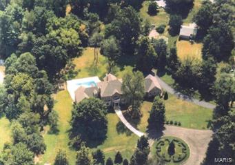Custom designed full brick home on 1.8 private AC in the heart of Ladue. Master Suite includes study w/built-in bookcases & fireplace; his & her baths; separate heating/cooling system. 2-sty Great Rm features custom fpl & expansive Pella windows overlooking pool & yard. Living Rm w/bay window & fpl; possible library/game rm; Kitchen, Breakfast rm; Butler's Pantry; 2 Powder Rms; & Laundry Rm complete main level. Upper Level includes 4 bedrm suites each w/private baths; balcony; & Laundry Rm. Finished walk-out Lower Level includes Family Rm w/stone fpl; home theater; pool table area; full kitchen;2 full baths; bonus rm; & Laundry Rm. Kool Deck surrounds the inground pool. A lily pond & patio are off the kitchen/great rm. Additional features include a finished oversized 4-car garage; copper gutters; 3 additional zones HVAC; 2 central vacuum systems; 400 amp electric service; commercial hot water heater; some wood floors; custom wood moldings.  Ladue School District; Conway Elementary.