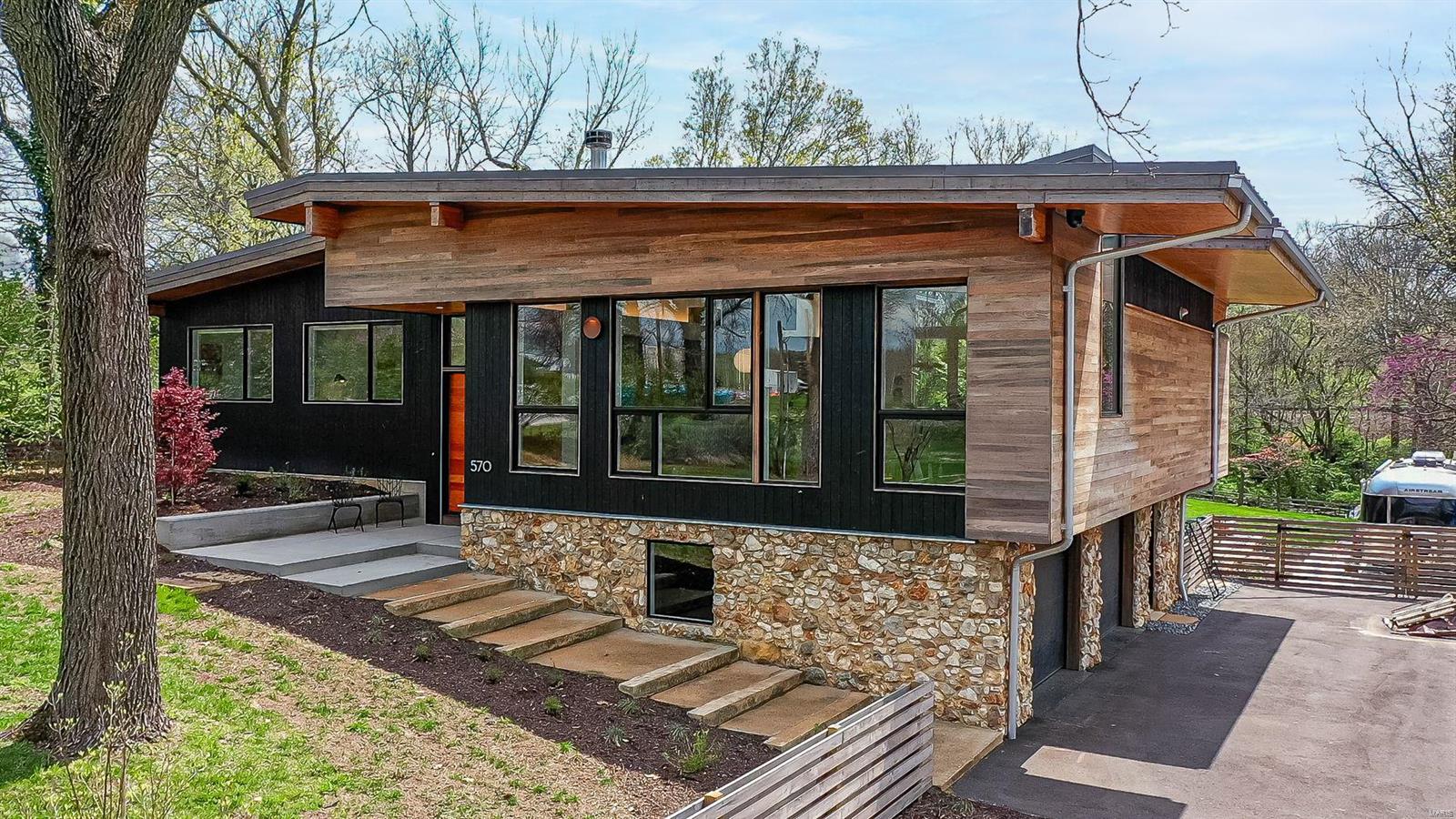 This newly built home is considered one of Studio Lark’s masterpieces. The current owners worked closely with designers to build a custom, contemporary home filled with every luxury. Pristine location on a private, almost one-acre lot across from Kirkwood Park- walk to the pool, theater & restaurants. The kitchen was created with a chef in mind featuring custom cabinets, Wolf ovens & gas cook-top and a Subzero fridge. The kitchen is open to the family room showcasing built-ins for an entertainment system & a wine fridge. A large deck overlooks the backyard. Stunning primary bedroom with a wall of windows & abundance of built in closets. The en-suite bathroom has a wet room with soaking tub & rain shower. 3 more bedrooms, full bath, powder room, casual den & office complete the main level. White oak flooring. The lower level has an in-law suite complete with a kitchen & a private entry. 470 bottle wine cellar. 2-car garage with workshop. High energy efficiency. Fully fenced backyard. Additional Rooms: Wine Cellar