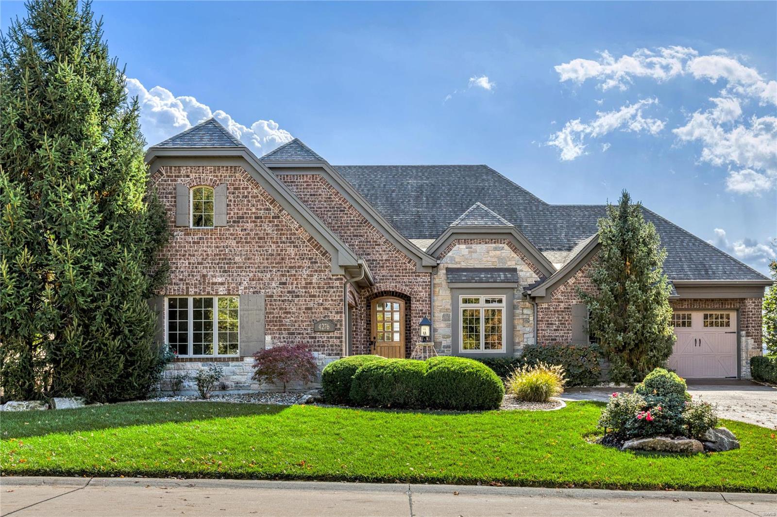 Exquisite Cross-built 1.5 Sty situated on a spectacular lot overlooking the Missouri River Valley. Coffered foyer leads to private study with 12’ ceiling, elegant dining room framed by arched entryways and stunning great room with cathedral ceiling, full-height brick & stone fireplace & dramatic bow window with unsurpassed vista views. Designer kitchen featuring glazed white cabinetry, granite countertops, Viking appliances, 8’ center island & adjacent sitting area adjoins breakfast room with French doors that open to covered deck. Primary bedroom suite with tray ceiling, wide bay window & luxury bath with jetted tub offers an appealing retreat. The 2nd floor extends the living quarters with a 2nd ensuite bedroom & bonus room. Lower Level includes recreation room with fireplace, 2nd kitchen & wine cellar plus guest suite & workout room (ready for finish.) Atrium door opens to outdoor living area with partially covered patio & paver patio with firepit surrounded by landscaped gardens. Additional Rooms: Wine Cellar