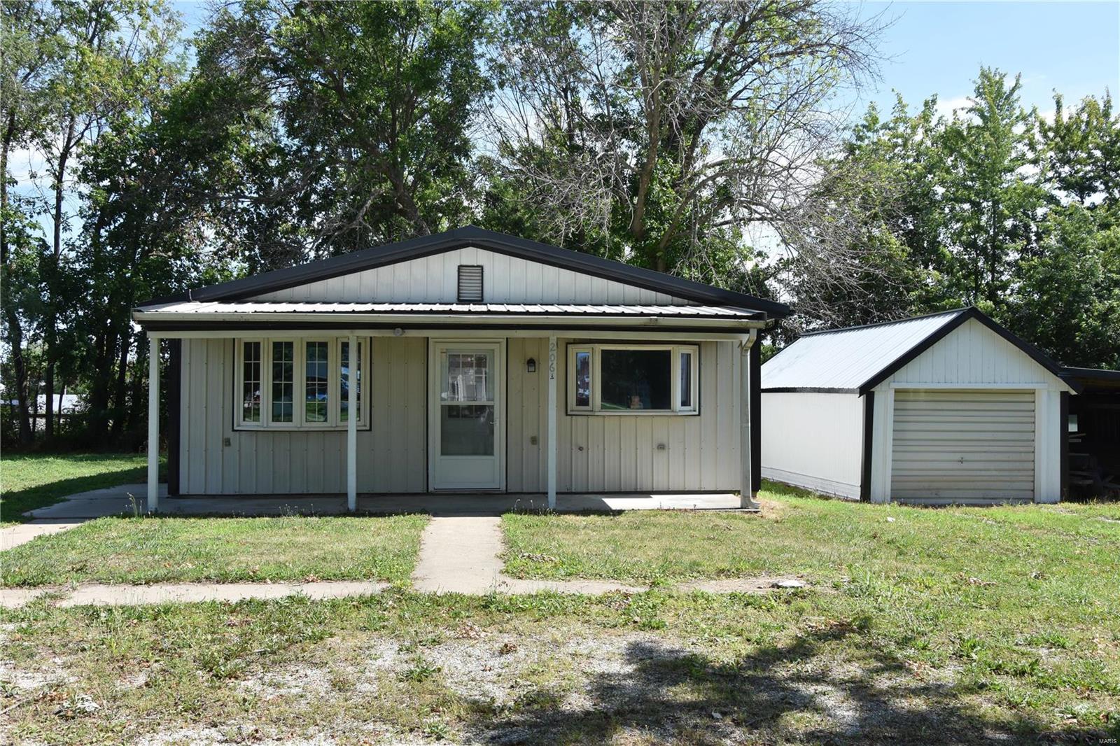 New Price! This easy to maintain, efficient and updated home is ready for a new owner and hard to find a place to live with room to build at this price in town! Great first home or add as a rental to your real estate portfolio. Detached garage with brand new metal roof offers additional storage. Comes with a level vacant lot on west side of the dwelling with plenty of room to build an additional building or home on it. Cash or Conventional offers only!