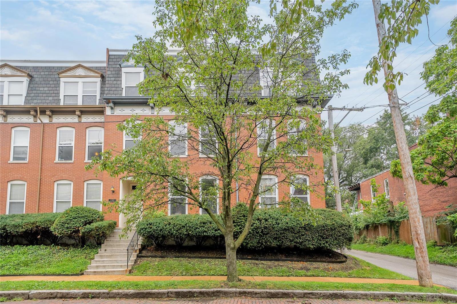 Est 1981: Well-updated 2nd floor END UNIT 2 bed/1 bath condo w/separate office space/library/bonus room! Featuring 1,100 sq ft, this move-in-ready unit features an open floor plan w/wood floors & crown molding thru-out, plus many updates & great natural light — just steps to the corner entrance of dreamy Lafayette Square Park! A spacious living room offers a central w/b fireplace that leads to a formal dining area w/breakfast bar overlooking the updated kitchen w/granite counters, newer cabinetry & SS appliances. The pantry includes side-by-side in-unit washer/dryer! Off the living room is a great bonus room/office w/built-in bookshelves. The hall bath has a newer vanity w/granite top & newer fixtures. The large primary bedroom offers a full wall of closets! A spacious 2nd bdrm connects directly to bathroom & features a walk-in closet & door directly out to your private COVERED outdoor balcony! 1 dedicated off-street parking space in the rear lot & storage locker in lower level. HURRY! Location: City