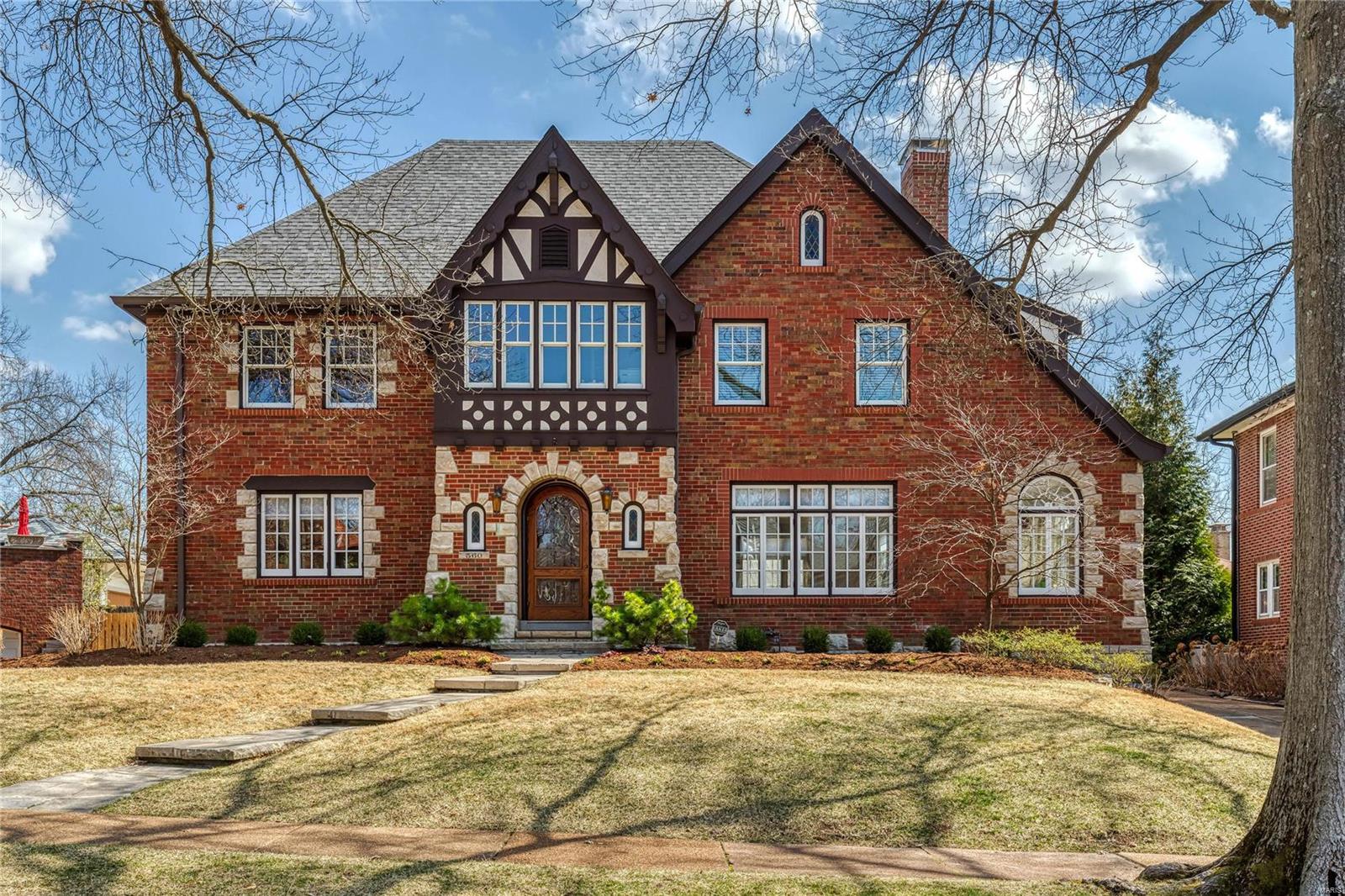A fine example of the marvelous architecture found in U-City. This elegant home underwent a meticulous renovation in 2016/17. Systems were replaced or renovated. New electric and plumbing in kitchen, all baths, and the new 1st-floor laundry. The original casement windows were restored. The boiler has been renewed w/additional zone for the FR. A new roof too. See the extensive list of improvements. Enter to find a spacious foyer w/circular stair open to large formal rooms & sunroom, an all-new kitchen, new family entry/mudroom with cubbies, laundry, and ½ bath.  Off the kitchen is the FR addition w/access to the patio & 3-car garage. Upstairs is a large master BR with ensuite bath & large walk-in closet. There are two other BRs & a hall bath. At the top of the stairs is a lovely home office. Completing this home is the lower-level rec room. This is a tremendous opportunity to be in U-Hills within walking distance to favorite local eateries, Flynn Park, tennis & Clayton. An A+ lifestyle. Additional Rooms: Mud Room, Sun Room