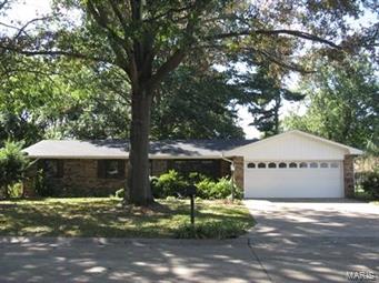 Tucked in between mature tress, you'll find this three bedroom two and a half bath home.  Tiled kitchen/dining combo and bathrooms.  Stainless side-by-side fridge.  Exposed brink in the kitchen and one living room wall with a fireplace.  Double sinks in bathroom makes for your family's convenience.  With lots of living space you'll love the formal living room and cozy family room off the garage and kitchen. Back exterior wall has been replaced with vinyl siding.