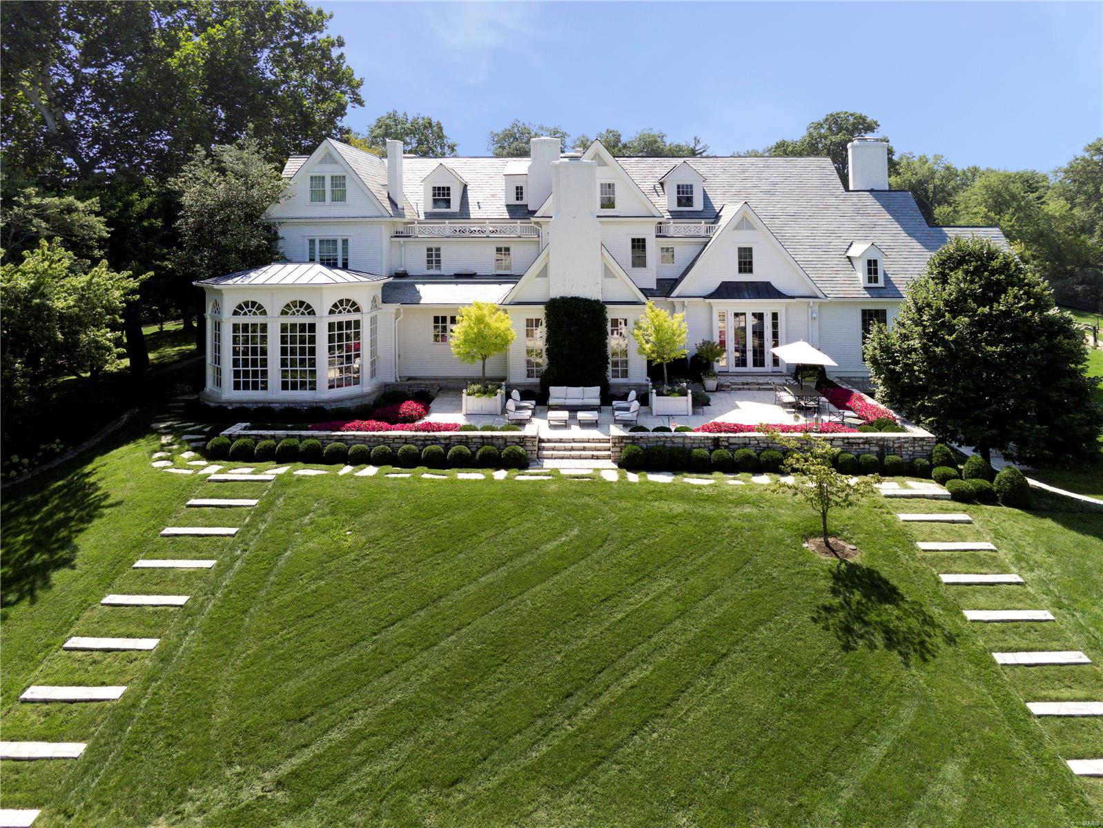 Stunning Ladue estate on 7.6 private acres with extensive gardens and mature trees.  Built in 1910 and extensively expanded and totally updated in 2006 with exquisite decor. Expansive outdoor entertaining spaces featuring a 1,000+ sq ft pool house.  With 14,400 sq ft of total living space, geothermal heating and cooling, garage parking for 13 cars, whole house generator, minutes from Clayton, winding front drive, this home is one of a kind. Elevator access to all four levels of the main house. 3 laundry rooms located on lower level, main, and second floors. Finished storage abounds.  Hardwood herringbone & marble floors on main level. Carpet and marble floors in 5 en suite bedrooms. Appliances in main and pool house include: Wolf, Viking, Dacor, & SubZero. Elegant finishes include: Trompe l'oeil painting, lacquered walls, combed plaster, soaring ceiling heights compliment the large scale of the the rooms, extensive millwork, and 8 fireplaces. Many details in photo captions. Additional Rooms: Wine Cellar