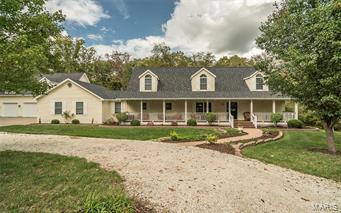 Looking for privacy, acreage, updates and garages? Look no Further! Tucked away on a low traffic road this Cape Cod Style 1 ½ Story home has tons to offer. 5 bedrooms, 4 full baths with 3 levels of living space and almost 4700 sq. ft. plus almost 5 ½ acres. If you have toys, this property comes equipped with an attached OS 2 car garage 24x23, OS Detached 3 car 46x28 and 12X12 Shed plus a huge 50x24 pole barn. Tons of updates throughout. Huge updated kitchen with solid surface countertops, tile flooring with lots of cabinetry. Main floor has a Master, 2nd bedroom with attached full bath and large 3 season room with a fantastic view. The upstairs has 2 Bedrooms, a full bath with an office and full loft adding a full secondary living room. If you are entertainers, the lower level is where the party is. The massive bar area doubles as a full kitchen with dishwasher, oven and refrigerators, easy access to the covered patio with another outdoor kitchen. Too much to list here so call today! Additional Rooms: Mud Room, Sun Room