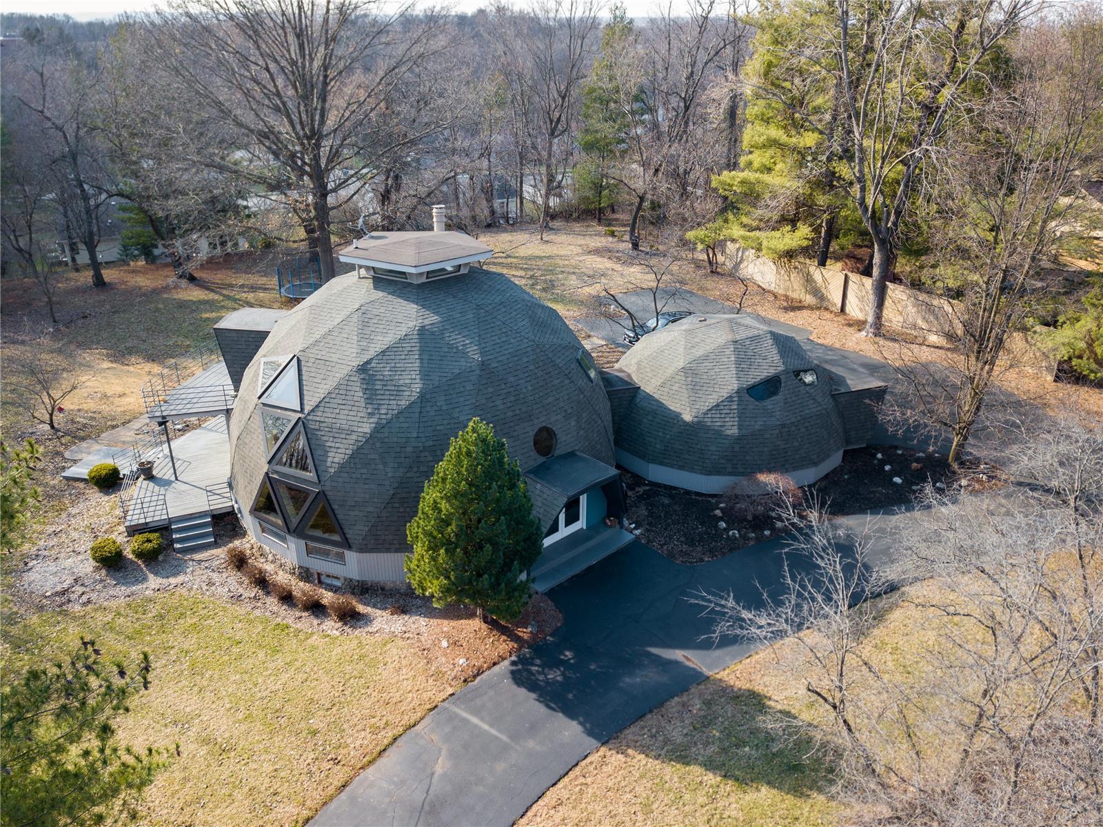 WOW! Built by engineer, Jon Mullinax, student of Buckminster Fuller, who invented and patent the geodesic dome. He also designed the Climatron at Botanical Gardens.  This one is Special! Unique, contemporary dome home with over 3,000 square ft. of living space seated on ONE FULL ACRE of beautiful scenery! Enjoy a gourmet kitchen featuring granite countertops, Sub-Zero Refrigerator, Dacor cabinets, custom lighting, wine cooler, Wolf warmer drawer and built in oven and microwave/convection oven, open to the dining room.  Master suite is full of light w/ large windows, built-ins, huge walk-in closet, private laundry and luxury master bath! Upstairs loft with 360 degree birds-eye-view perfect for an office, playroom or your own retreat. Walk out lower level with a media room, bath snd kitchenette.  From the expansive deck, overlook the gorgeous park-like acre. Easy highway access, close to Creve Coeur Park and Lake, and located in award winning Parkway schools, this home won’t last long.