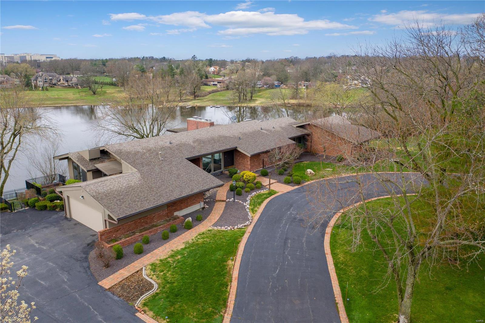 Price reflects as is sale and need for improvements. Sensational mid-century home with captivating lakefront lot. Priced near lot value alone!  Over one-acre lot! The setting of this California soft contemporary one-level home is superior to most waterfront homes at Lake of the Ozarks. Stupendous views from nearly every space. Floor plan is very much like an atrium ranch. Owner's suite has private screened porch perched above lake. Lower level is full daylight and walk out. Large level area overlooking lake. Substantial, newer retaining wall. Private dock.  Home, lot, and dock all sold AS IS. Circular drive allows you to pull up to the front door. Enter an amazing glass enhanced residence with enormous living/dining room with vaulted ceilings and magnificent view. Cozy galley kitchen with transom windows leads to side entry garage and sun filled breakfast room with private patio. Spacious bedrooms and an enormous owner suite with fireplace and ample closet space. Finished lower level.