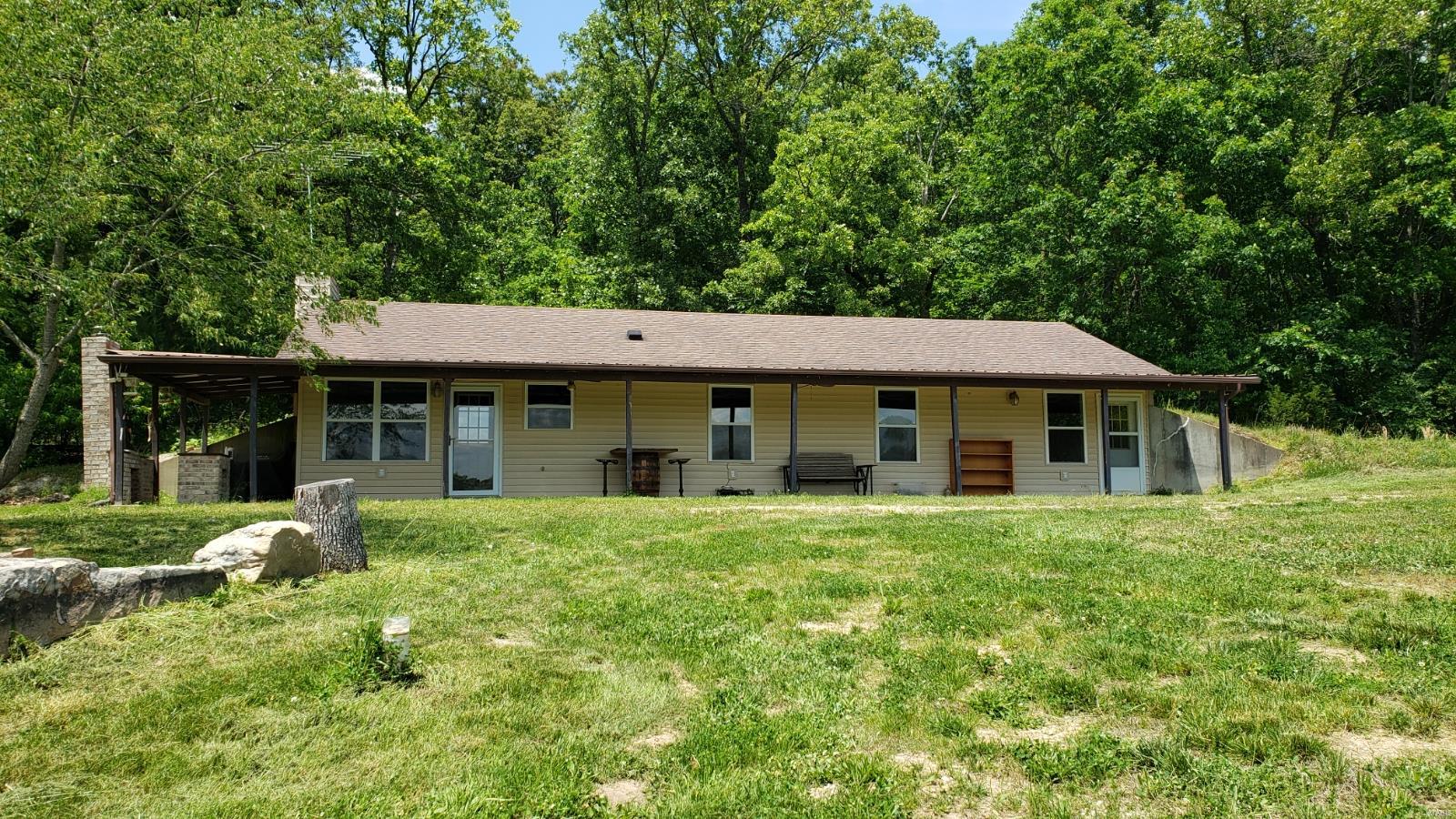Beautiful & picturesque 51 acres for your consideration. 3 Bed 2 bath home w/ covered front porch to enjoy the view of the stone fire pit, pond & the hills beyond. Large detached Outbuilding w/ overhead door for equipment storage & carport. This property can serve many purposes. Bring your family, Atv's, pets & hunting friends to enjoy the weekends on the trails, hunting, & fishing, cooking on the brick outside grill or bring your family & make this oasis your primary residence! The owners have made many improvements recently to the property including: New gas stove, range vent, & microwave. New master bath vanity, sink, toilet, & shower doors. New solid doors throughout the home. Stocked the pond w/ (100) 12" catfish, (50) largemouth bass, (500) bluegill, & different bait fish. The fish have been fed high protein pellet food every year since stocking. Ran electric to pond for aerator to create oxygen in the pond. Created (2) Whitetail Institute clover food plots. This is a rare find!