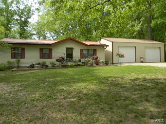 Who's the Lucky Buyer?!  Get ready to move right in to this cute home situated on a 1.2 acre lot w/mature trees for lots of shade!  A woodburning fireplace can be found in the nice sized living room that flows into the bright dining area, while the kitchen offers a tin style backsplash, a nice touch to the handy workspace.  Three bedrooms include great closet space w/the master offering two closets plus a convenient half bath.  Lots of space in the walkout basement to finish or use as storage space, where two rooms have already been created & just need the finishing touches.  Enjoy the covered deck, overlooking the large backyard, for a place to relax  The man of the family will LOVE the new oversized garage w/10 ft doors & heaters, so you can work there all year long!  NEW metal roof & NEW heat pump furnace/AC await the lucky buyer!  Septic drain field updated in 2015.  Laundry could be moved back upstairs.  This is the place you'll want to call HOME!  Repairs are done...SOLD AS IS