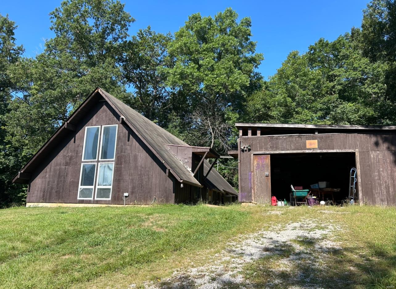 Check out this A Frame style home in the Rockwood School District! This fixer upper home offers so much potential and needs some upgrades, but offers the remote lifestyle on 3+ acres of land that backs to woods with no restrictions. Country living at it's finest! You cannot see the home from the road, so you do have plenty of privacy in this location. The vaulted ceilings are sure to impress as you enter the 3 bed/ 2 bath home. The home does need a new Furnace and AC, but is currently set up and duct work is in place and ready for a new unit. There are 2 window AC units and a wood burning stove and portable heaters in the home. There is conservation area, hiking, and Don Robinson State park nearby to enjoy nature. The access to I-44 is close for a quick commute to anywhere. So much potential and ready for a new owner that is ready to make this one their own.
