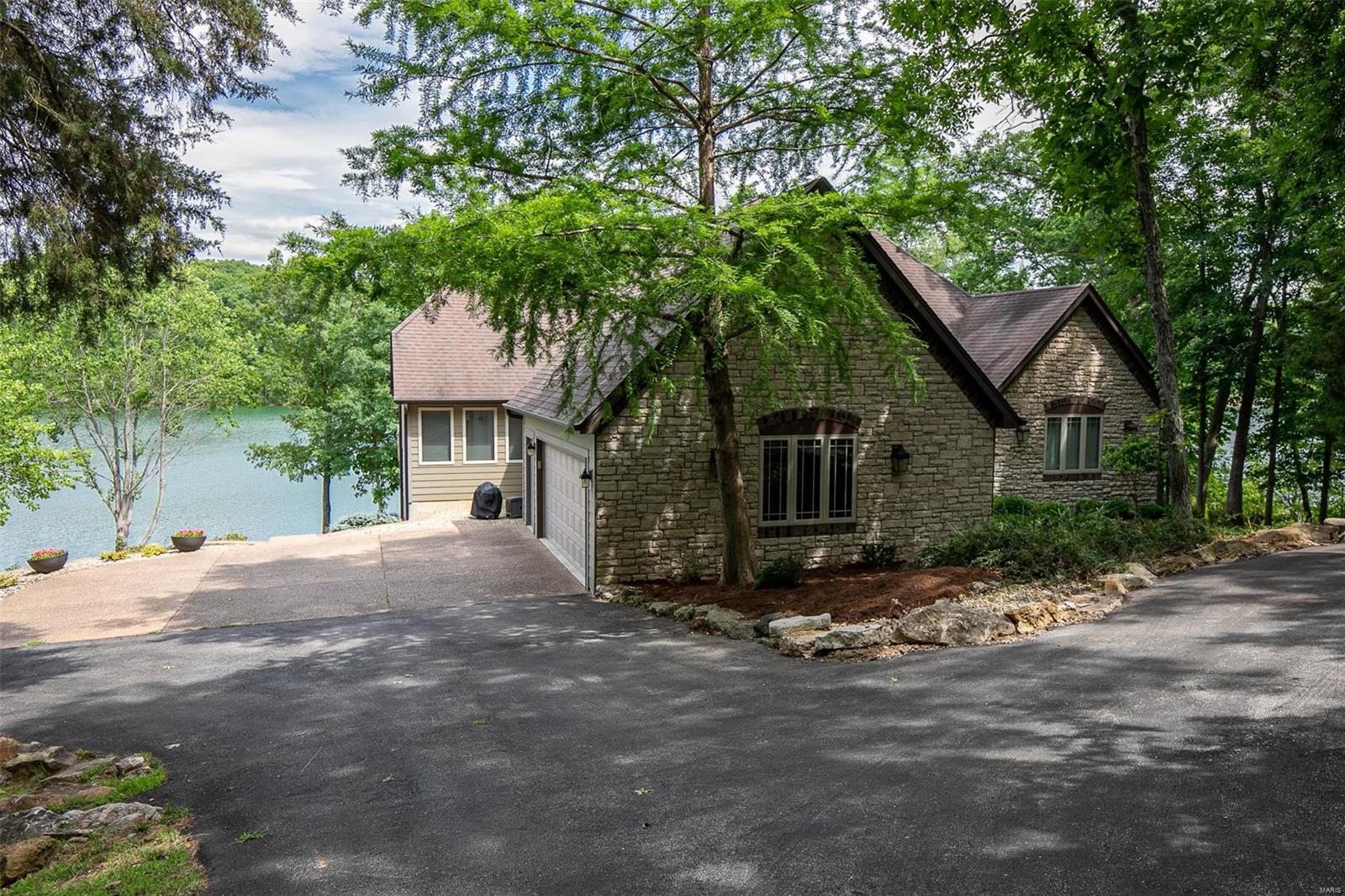 INCREDABLE VIEW!!! EASY LAKE ACCESS!!! PRIVACY!!! This is a one of a kind home situated on a gently sloping lot with easy access to the waters edge. Situated amongst towering oak trees is a little piece of paradise waiting for you.  There was no spared expense in the thought process when creating this perfectly positioned home to achieve every view imaginable. This home offers 5 bedrooms, 4 baths, a beautiful stone fireplace, custom cabinets, and incredible hand scraped wood floors!  If your in the market for a fantastic lake property that has it all...look no further.  See for yourself with a tour of this wonderful offering. Property is being offered turnkey to include all furnishings and pontoon boat.