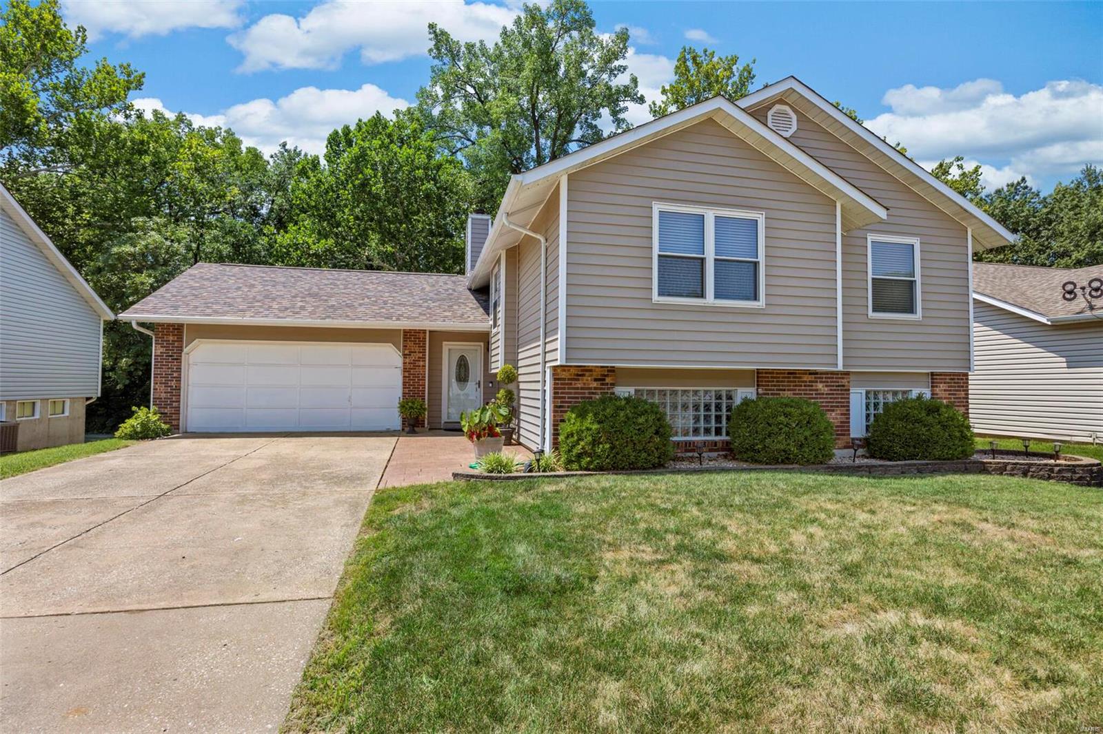 You'll love this spacious home w/tons of finished space, walk out lower level, deck w/vinyl rails/spindles & amazing stamped concrete patio, backing to woods/walking path! Updated carpet on steps & lower level & updated laminate flooring in vaulted great rm, hall & master bdrm! Vaulted kitchen & dining area w/tile floors & backsplash! Updated stainless appl incl refrigerator, smooth top stove & new dishwasher (7/22)! Walk out to large deck over looking private back yard/woods! Lg newly painted master bdrm w/private access to full bath w/dbl sinks + 2 addl bdrms. Updated carpet in lwr lvl, new stacked stone (5/22) surrounds wb fplc in spacious family rm w/lg windows! Recreation area & walk out to awesome stamped concrete patio/private yard! Full bath & plenty of space in unfinished area w/egress size wndws to finish a 4th bdrm if desired! Built in storage shelves as well! Hot water heater new 6/22, roof 5+/- yrs, HVAC 8+/- yrs old. Deep garage, encl soffits/lg lap vinyl siding,more!