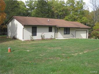 1 +/- acres offering you privacy plus located close to the highway on a level, mostly fenced acre. Featuring a 2 bedroom, 1 1/2 bath home with an attic fan, oval leaded glass entry door and an attached 2 car garage with opener, fenced yard, large storage building, mature trees, double deck and ready for immediate occupancy, all for $114,900.00! Additional Rooms: Mud Room