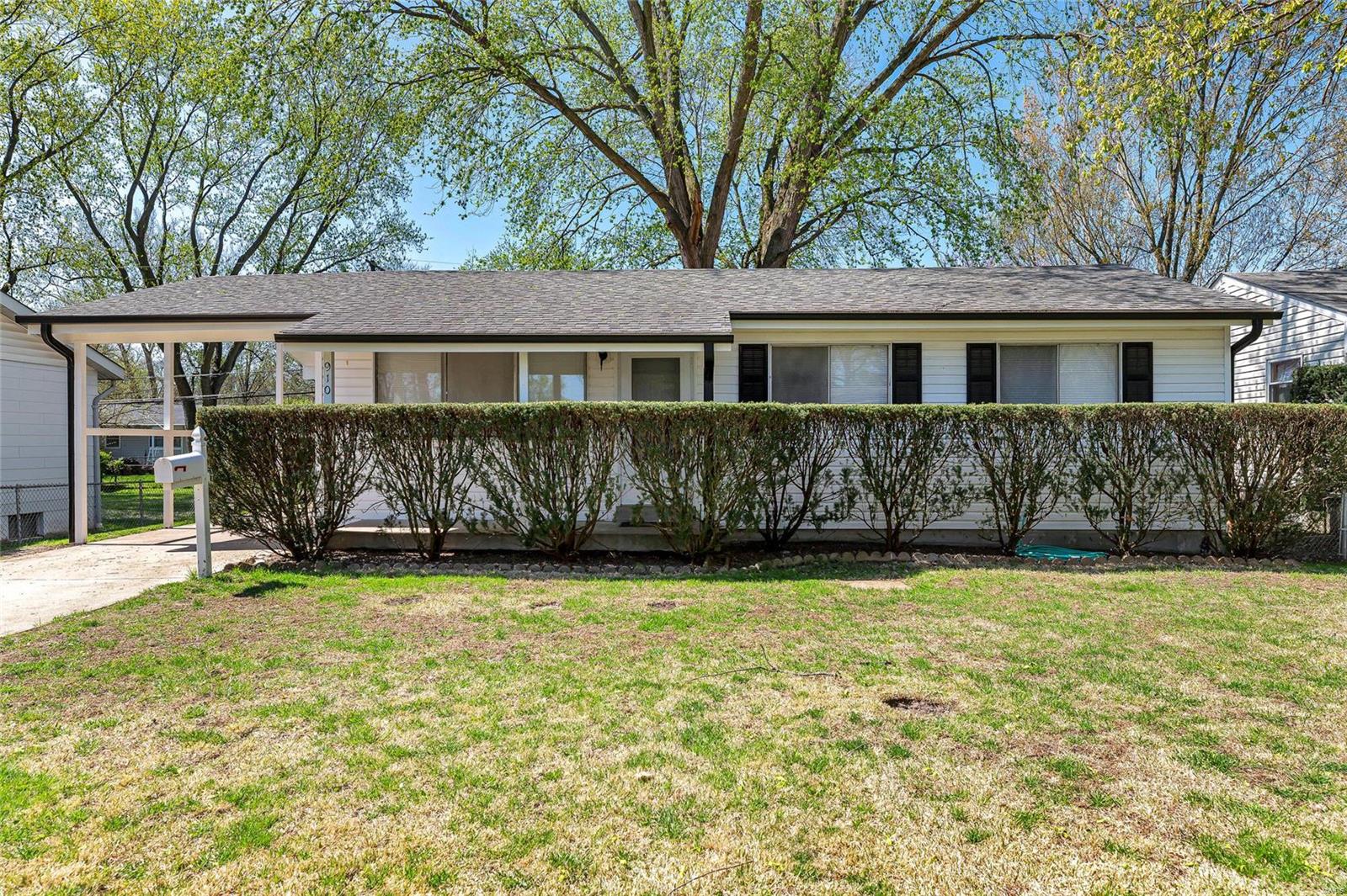 Welcome to 910 Lilac Drive located in Florissant.  This easy-to-show 3 bedroom home features original hardwood floors and 6 panel doors.  New flooring in the living room, hallway, kitchen and lower level.  This 1.5 bath ranch is move-in ready.  The exterior is low maintenance siding and new soffit & fascia.  Spacious living room with a large picture window for natural lighting, leading into the kitchen which features an eat-in dining area set in a bright room with two large new windows.  The kitchen also has new cabinets, countertops and appliances.  The lower level offers a family room, rec room, built-in bar, laundry and storage area.  The backyard is fully fenced with patio, large tree, hot tub, and shed for your outdoor enjoyment.  Location has easy access to highway; it is located within walking distance to St. Ferdinand Park.  Convenient access to shopping, restaurants, and so much more.