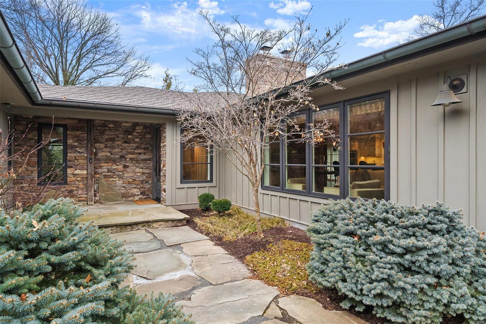 Welcome to #3 Rutherford Lane, a distinctive Mid-Century gem on 1.35 acres and private cul-de-sac in prestigious Town & Country. Newer custom windows saturate over 4,400sq ft. with natural light. Modern yet comfortable, not a detail was overlooked. Classic Mid-Century high ceilings, wood beams and floors. Wide open Living, Hearth, and Dining Rooms boast double wood-burning fireplaces. For the entertainer, a newer gourmet kitchen with top-tier appliances, custom cabinetry, and sprawling island. The primary suite and bath are their own retreat. Two additional bedrooms with ensuite baths & custom closets, and a perfectly appointed office space. Outside, a private oasis awaits w/pristine pool, hot tub, tree house & lush gardens, backing to T&C town square park. A spacious mudroom w/extra storage and sink, finished Lower level w/high ceilings, a full bath & 2 king-sized Murphy beds for guests, and finally, a long driveway & 4-car gar w/ custom storage complete this Mid-Century experience!