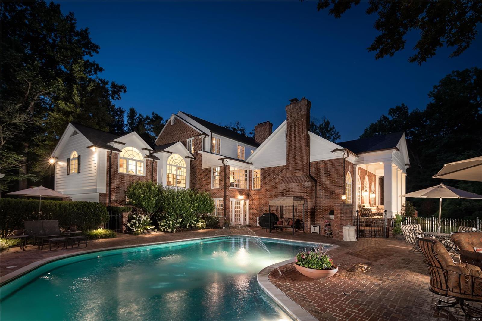 Phenomenal New price makes this Ladue hideaway the Best Value in Ladue! This stately Georgian colonial is set in an exceptional setting, is completely private, and at the end of a private lane. Current owners transformed the home to excellence in condition, which is flawless. Lush gardens and artistic landscaping are keynotes that have been additions to the 1.4 acre setting, as well as a new roof, gutters and downspouts. Find an inground pool and remodeled pool house. The main level Master wing provides dual baths, dual organized closets and a separate staircase leading to the gym. Three additional suites are on  second level. The office is one of the hone's most interesting features, with a mezzanine level view. The Great Room addition is comprised in French doors, palladians which flooded natural sunlight. Large living and dining Rooms. The walkout lower level has an all new full kitchen and bar, for servicing the pool, outdoor entertaining and patios of the property.