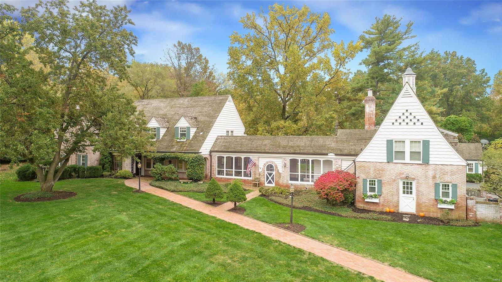 GREAT NEW PRICE! Who doesn’t want to live at the end of a storybook lane, tucked away and in a serene natural setting on one of Ladue’s premier streets...?  Here you will find one of those homes that makes one take notice.  The whitewashed brick of the main house.  The quaint cottage, the outdoor patios, the fabulous screened porch and the private guest quarters (4th bedroom) over the attached garage.  A gracious entryway leads to an inviting living room with one of 4 fireplaces in the home.   Large family room with walnut paneling overlooks the back yard.  Formal dining room and sun-filled eat-in kitchen.  Master bedroom suite, also with fireplace, has been tastefully renovated and expanded to include a luxurious en suite bathroom.  This picturesque country estate could be yours! Additional Rooms: Sun Room