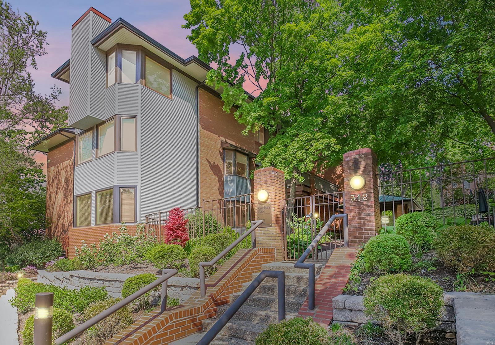A rare opportunity to procure a stunning ground-floor, double unit condo with over 3,100 square feet of living space in sought-after Kingsbury Place. Three sides of exterior views, two of which are flanked by spacious covered terraces. Inviting formal Living and Dining rooms are graced by a wall of windows, and feature the first of two fireplaces, a custom wet-bar and a stunning neutral palette. The spacious Kitchen features gorgeous custom cabinetry and a massive center island. Escape to the quiet den, featuring custom bookcases surrounding the cozy fireplace, wood floors, and access to the courtyard-facing terrace. Expansive Primary Suite features a large sleeping space with custom walnut built-ins, a private Office/Library/dressing space, a spacious walk-in closet and gorgeous Bath. A secondary Bedroom and full Bath complete the sleeping quarters. Enjoy the elegant Clayton lifestyle with walkability to fine dining and entertainment. Location: Ground Level
