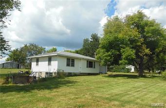 Welcome to the homestead with blacktop frontage in Lincoln County. Troy Schools, no restrictions, 1.5 acres m/l. Pulling in you'll see Grandma's log cabin with stone fireplace. Ranch home with new roof, siding, bathroom, paint. 2 bedroom, 1 bath full walkout basement, 1 car attached garage plus carport.  Public water hooked up. Public sewer available at buyers cost. Seller selling home in "As Is" condition. Hard to find not in a subdivision.