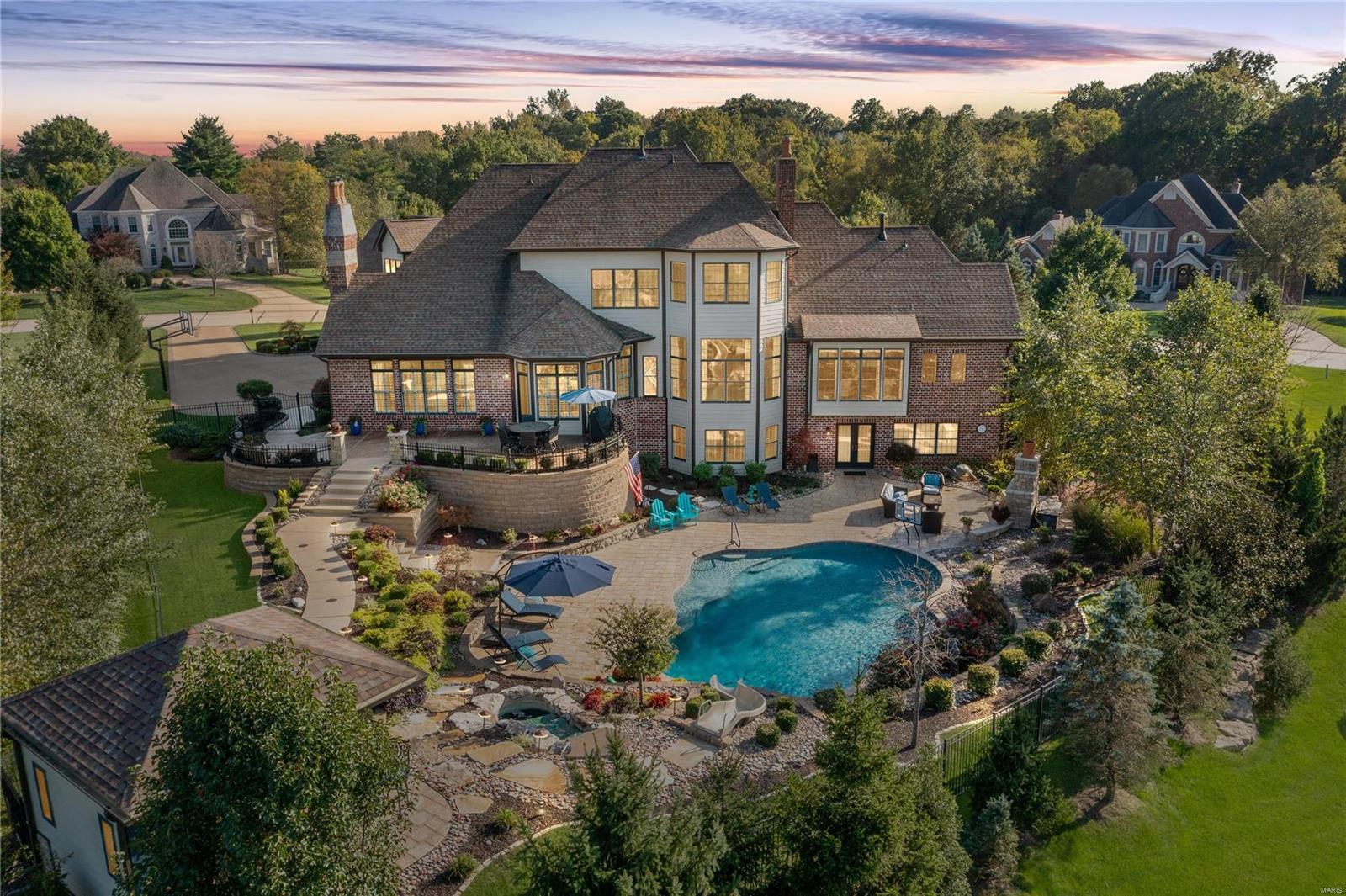 Distinctive Collection in a prestigious gated neighborhood in Town & Country. This custom executive home in Devonworth has an open floorplan & dramatic appointments. Elegant curb appeal, w/brick & stone elevation, massive arched walnut door, circle drive, 4 car garage. Foyer features vault ceiling, natural limestone floor. Extensive millwork, pewter hardware, solid alderwood doors throughout. Library w/14’ ceiling, built-in cabs/shelves, bay window, wood floor. Gourmet kitchen w/Thermadore appliances, custom wood cabs, granite, & limestone floors that spill into Hearthroom, w/cathedral wood beamed ceiling, stone FP. Main flr Master Ste w/coffered ceiling, wood floor, his/hers closets, & Bath w/limestone heated floor, jet shower, jet tub. 4 BRs, 4 baths upstairs, AND 41 x 23 Bonus room. Finished W/O LL has limestone floors, distinguished bar, wine cellar, family & game rooms, full bath. With over $700,000 in upgrades, this Luxury Home is a must see. COOL: 14 SEER+