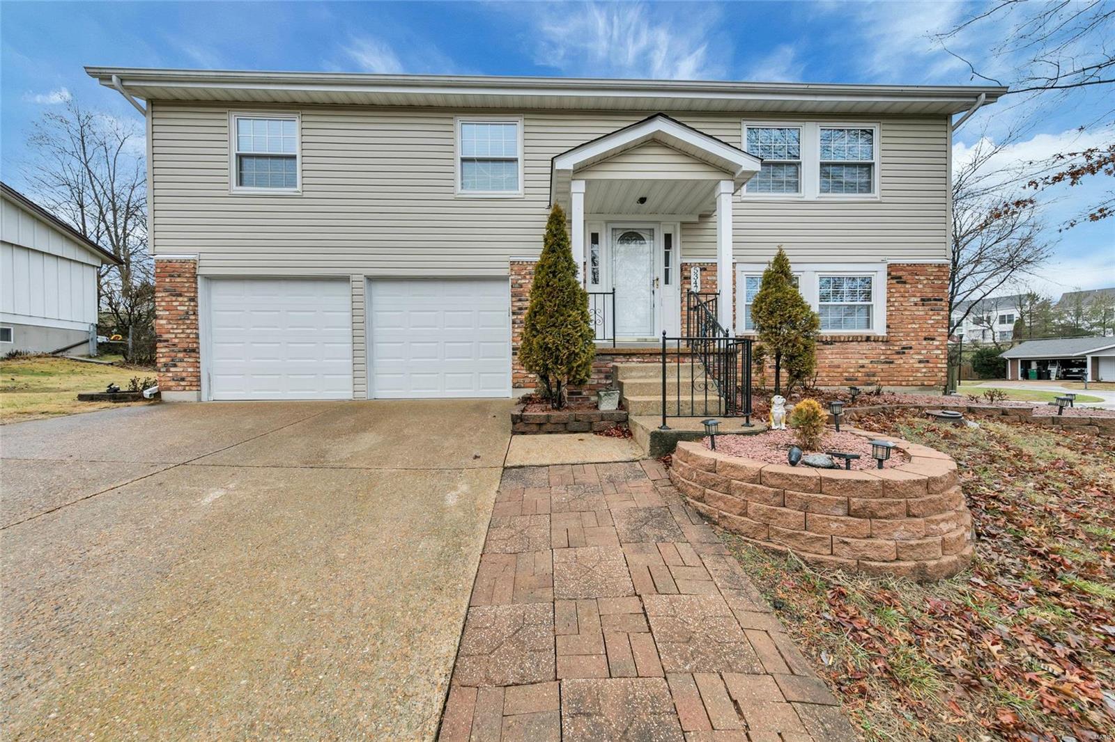 Great home in a wonderful location!! Close to Gravois Bluffs, Suson Park, shops & restaurants with easy access to highways! With oversize driveway accented with pavers & professional landscaping, this home offers excellent curb appeal. As you enter this home the first thing you will notice is the gorgeous new wood flooring through out as well as beautiful neutral decor! This home shows like a display! The updated Kitchen offers 42" wood cabinets, new counter tops, tile back splash, gas range & new stainless steel sink w/garden window overlooking the large yard. The spacious master suite offers crown molding, large closet & completely updated Master Bath. 2 additional spacious bedrooms along with another full updated bath complete the main floor. Additional living space can be found in the finished walk out lower level offering a large Family Rm w/custom built-in shelves, crown molding & full light glass doors lead to large concrete patio. This home is sure to please!