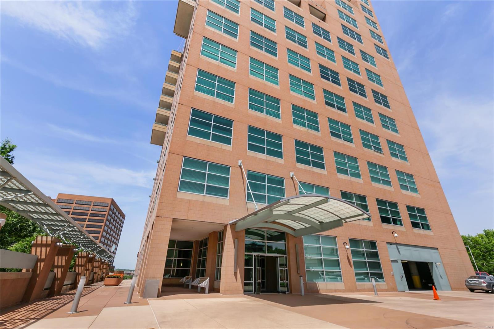 FANTASTIC PRICE REDUCTION!  GREAT VALUE!!!  This sophisticated 2 bed, 2 bath unit offers open light filled spaces and beautiful views of Clayton!  The current owners have made updates that include gorgeous quartzite counter tops and backsplash, some new custom cabinetry, new kitchen sink/faucet, new designer carpeting in bedroom, lighting and more.  The kitchen/living room open space features wood flooring, and a wall of windows to the 11 ft high ceiling.  Motorized shades make it a breeze to turn in for the evening.  The master includes a sitting/room office with private covered balcony, bath with double sinks and a walk-in custom closet.  In unit laundry, 2 well located covered parking spaces complete this offering.  Maryland walk is a luxury building that offers 24-hour doorman, 3 guest suites, security, pool, work out room, media room and fantastic rooftop party room and terrace with sweeping views. Location: Upper Level