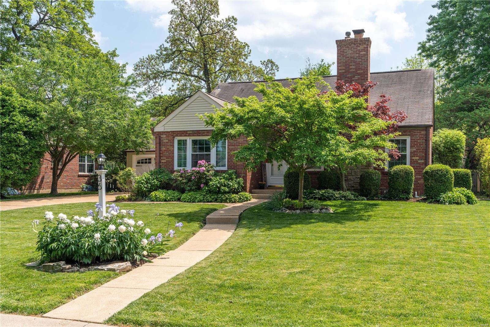 Est. 1942. Beautiful landscaping and tons of curb appeal welcome you to this 3 bed/2 bath home located in Webster Groves. The entry foyer opens through archways to the light-filled DR and large LR, offering custom built-in bookcases with integrated LED lighting and woodburning fp. Refinished wood floors and crown molding complete the spaces. Updated kitchen with custom cabinetry, granite countertops, subway tile backsplash and ss appliances, flows into the sunroom - use it as a family room, office or whatever fits your lifestyle! The fabulous screened-in patio with built-in electric fp is the perfect spot to entertain or enjoy quiet evenings overlooking the private, fenced-in backyard. The primary bdrm with double closets along with an updated full bath complete the main level. The 2nd flr includes 2 good-sized bdrms, both with double closets, and another full bath! 1 car attached garage. Walkable to Blackburn Park, WG Rec Center and neighborhood schools. This gem won't last long!