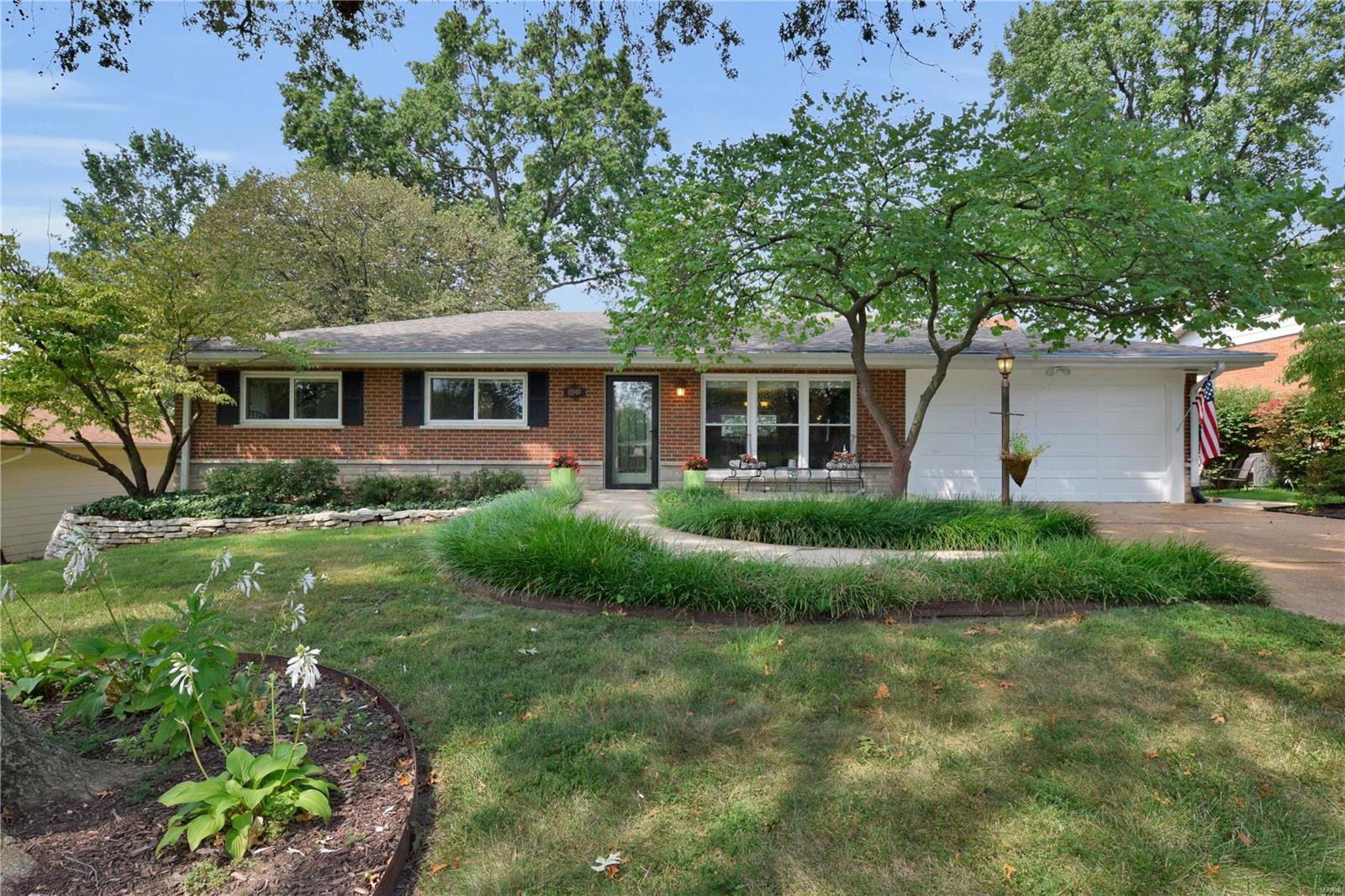 This refreshing Crestwood ranch features a bright and spacious open floor plan. The home has been impeccably maintained and upgraded with high end finishes including crown molding, insulated windows with 2 inch blinds throughout, exterior doors with built-in blinds, extra wide 6 panel doors and tiger wood floors throughout. The kitchen has solid cherry wood cabinetry from Fieldstone, high end countertops with a stainless sink, ceramic tile and a built in pantry, plus room for an island. The sizeable, well landscaped backyard includes multiple entertaining areas. 3 bedrooms and 2 baths complete the main level including French doors in the master that open to a private deck. Entertain in the large, multi-functional, carpeted lower level with a half bath, laundry room and 2 storage areas. The list continues-quiet, tree lined street, Lindbergh Schools, walking distance to Crestwood Park, gutter guards, 2 car garage, a fireplace, plus a laundry chute! Come see for yourself!